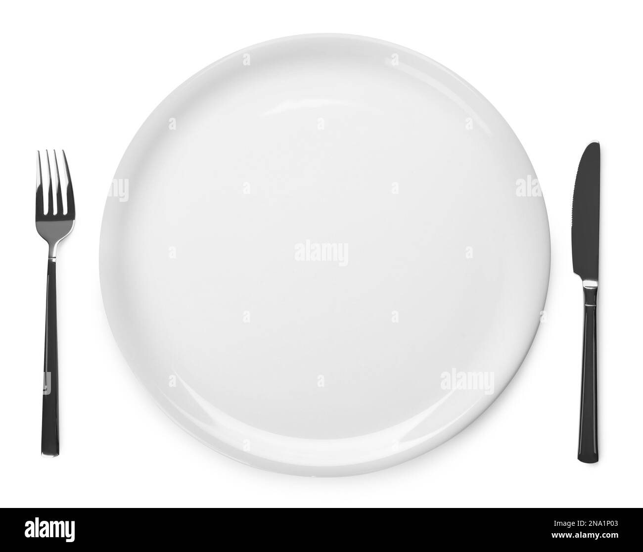 Assiette et couverts sur fond blanc, vue du dessus Banque D'Images