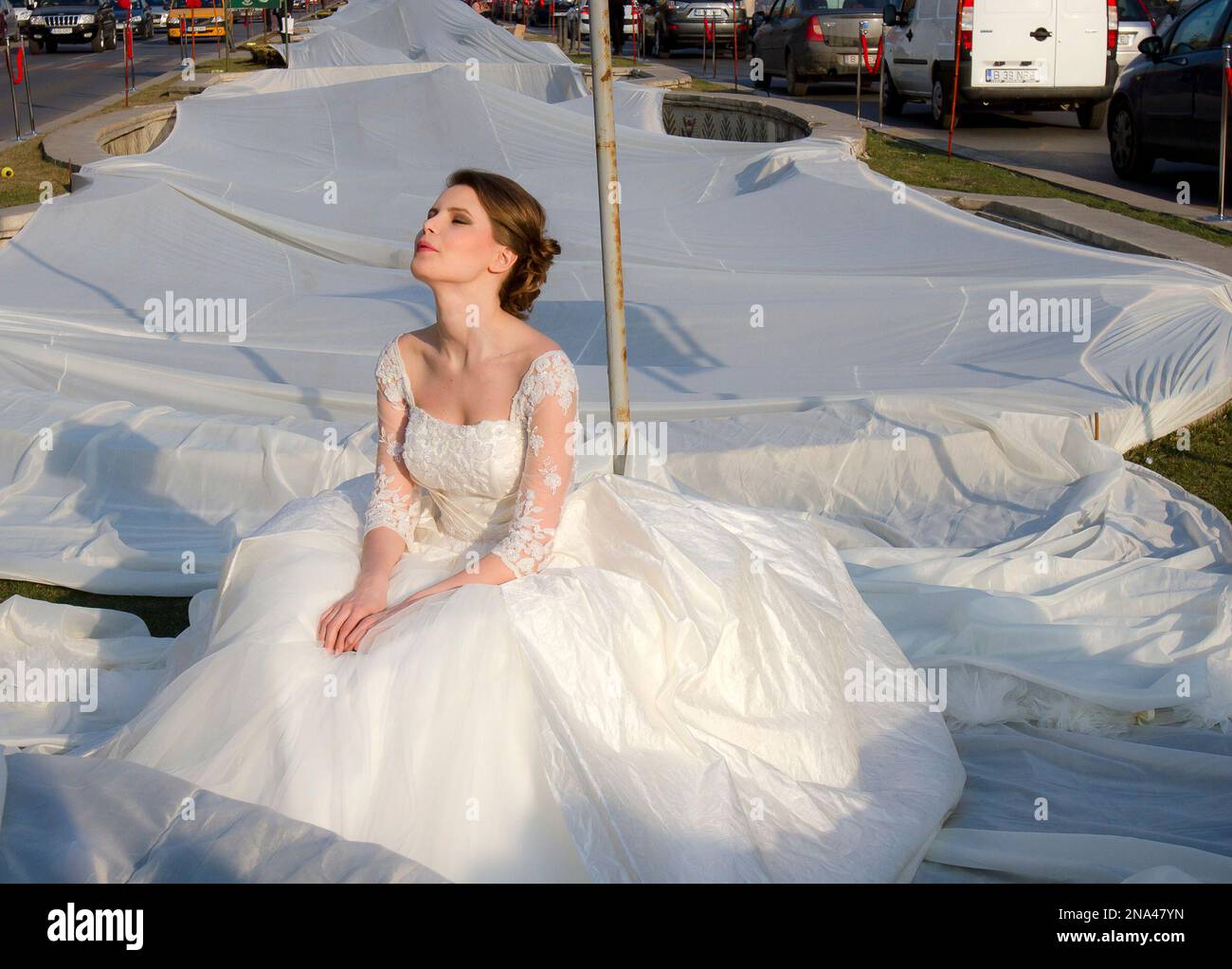 Emma Dumitrescu 17 years old a model poses to show the worlds longest wedding dress train during a Guinness World Record attempt in Bucharest Romania Tuesday March 20 1012.Romania has set the