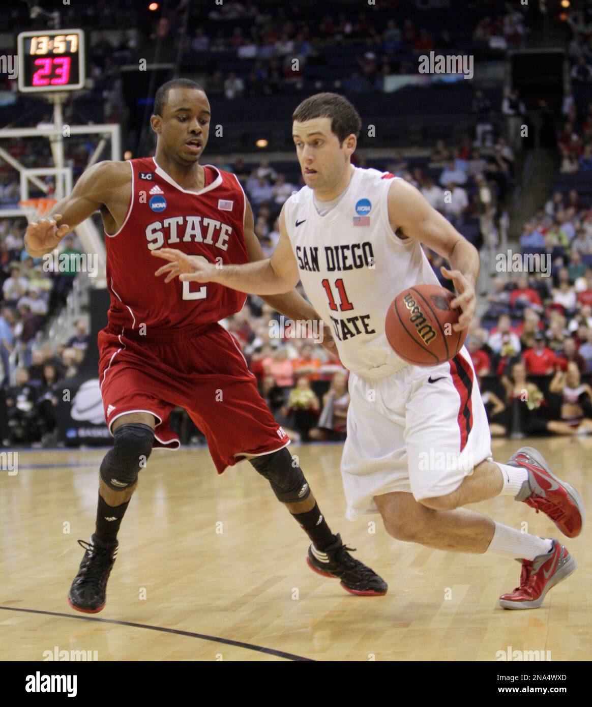 San Diego State's James Rahon (11) drives past North Carolina State's Lorenzo Brown (2) during the first half of an NCAA men's college basketball tournament second-round game in Columbus, Ohio, Friday, March 16, 2012. (AP Photo/Jay LaPrete) Banque D'Images