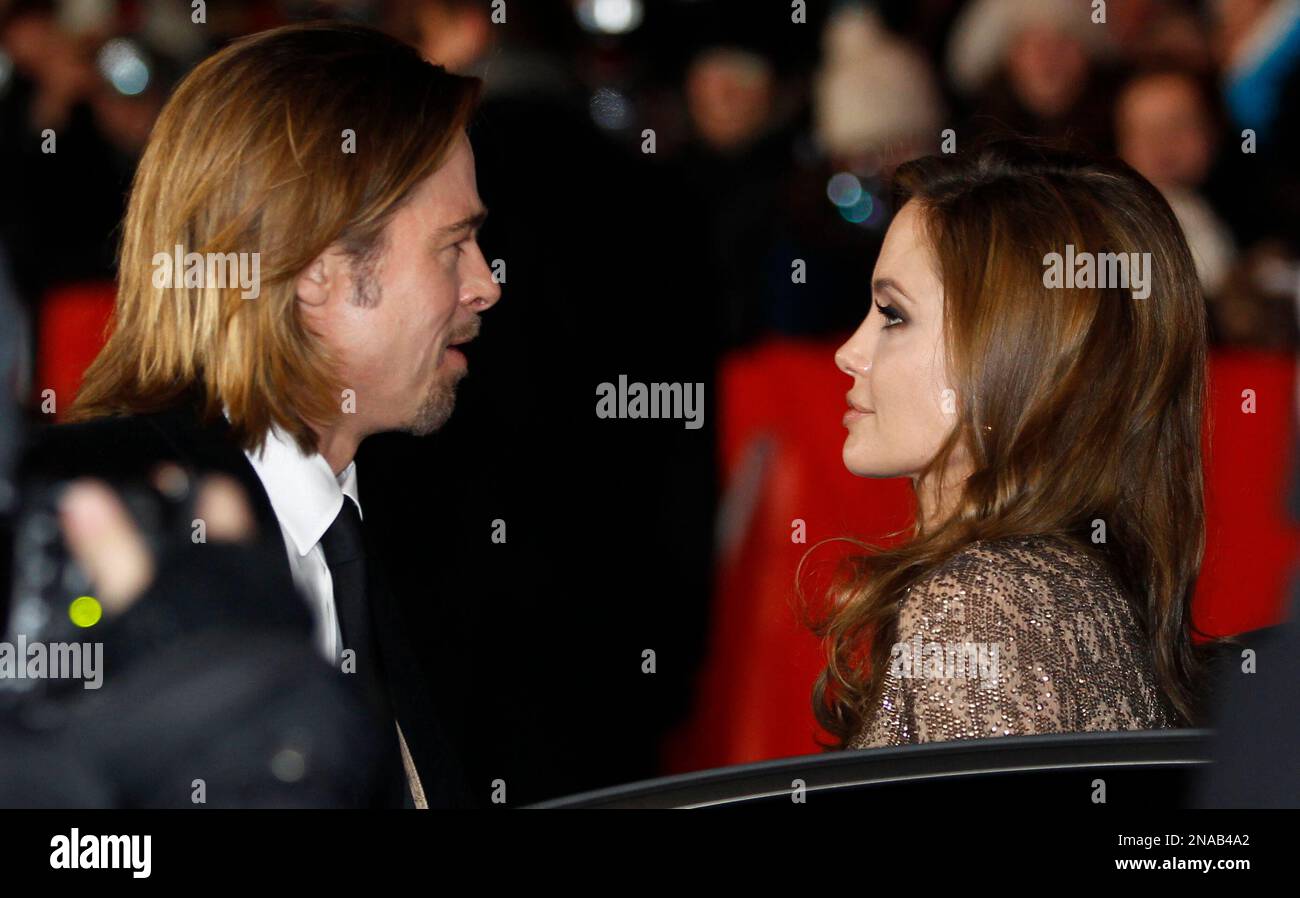 US director and actress Angelina Jolie, right, and her partner US actor Brad Pitt arrive for the screening of the film In the Land of Blood and Honey at the 62 edition of the Berlinale, International Film Festival in Berlin Saturday, Feb. 11, 2012. (AP Photo/Michael Sohn) Banque D'Images