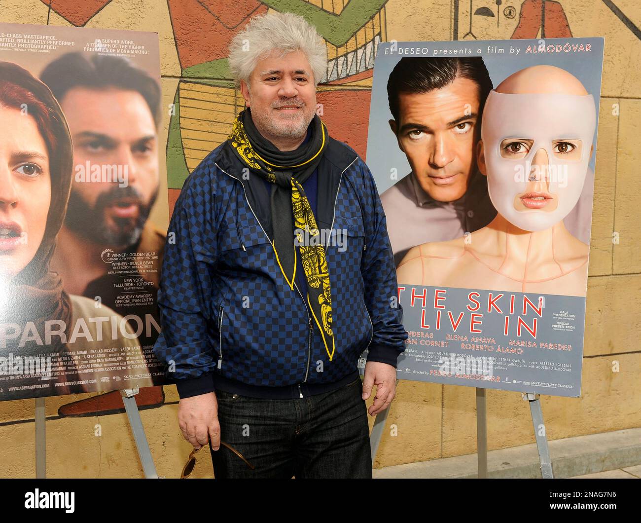 Pedro Almodovar of Spain, director of the Golden Globe-nominated foreign language film "The Skin I Live In," poses near the film's poster at the Golden Globe Foreign Language Nominees Seminar, Saturday, Jan. 14, 2012, at the Egyptian Theater in Los Angeles. (AP Photo/Chris Pizzello) Banque D'Images