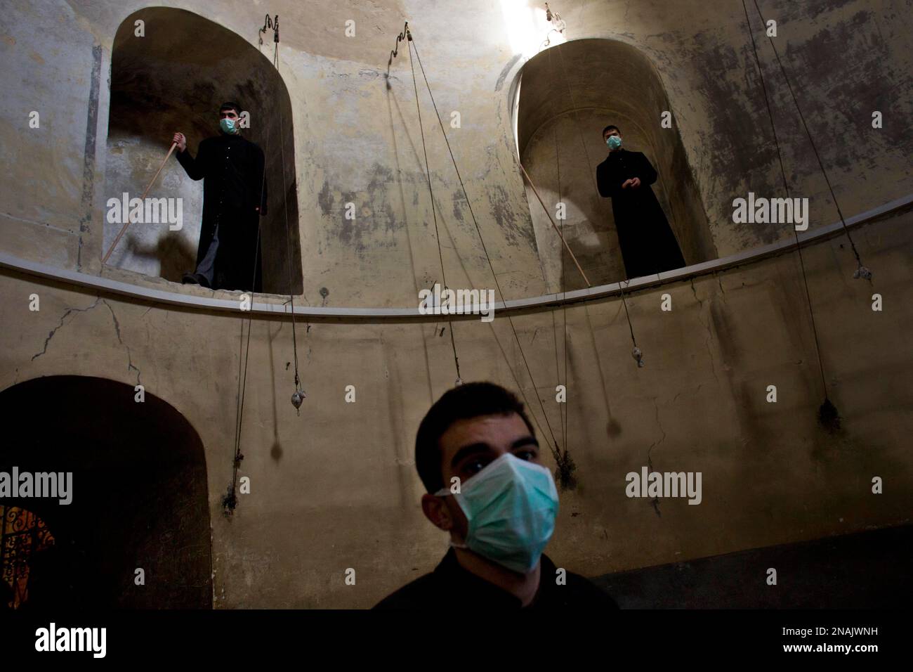 Armenian Orthodox clergymen prepare to clean the Church of the Nativity, believed by many to be the birthplace of Jesus Christ, in the West Bank town of Bethlehem, Wednesday, Dec. 28, 2011. Armenian Orthodox and Greek Orthodox clergymen screamed at each other and beat each other with broomsticks during Wednesday's cleanup inside the Church of the Nativity, when the sides accused each other of crossing into each other's territory. (AP Photo/Bernat Armangue) Banque D'Images