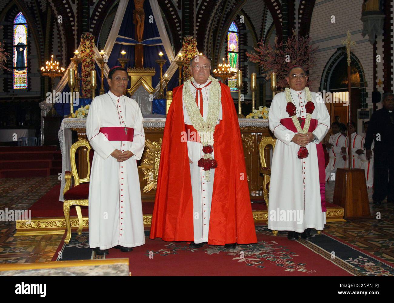 Cardinal Renato Raffaele Martino, center, a Vatican envoy, attends a ceremony to mark the 100th anniversary of the founding of St. Mary's Cathedral in Yangon, Myanmar, on Wednesday, Dec. 7, 2011. Other priests unidentified. (AP Photo/Khin Maung Win) Banque D'Images
