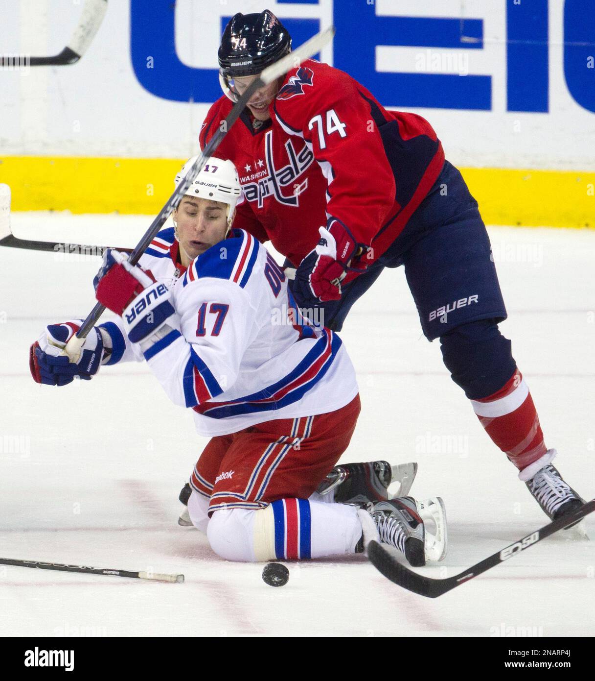 Washington Capitals defenseman John Carlson (74) fights New York Rangers left wing Brandon Dubinsky (17) for control of the puck during the second period of an NHL hockey game on Friday, Nov. 25, 2011, in Washington. (AP Photo/Evan Vucci) Banque D'Images