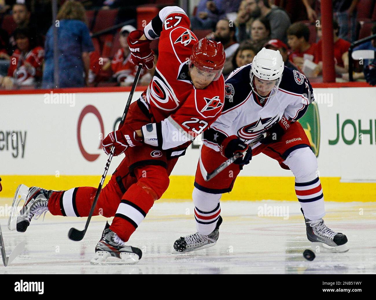 Carolina Hurricanes' Alexei Ponikarovsky (23), of Ukraine, and Columbus Blue Jackets' Tomas Kubalik, of the Czech Republic, chase the puck during the second period of a preseason NHL hockey game, Friday, Sept. 30, 2011, in Raleigh, N.C. (AP Photo/Gerry Broome) Banque D'Images