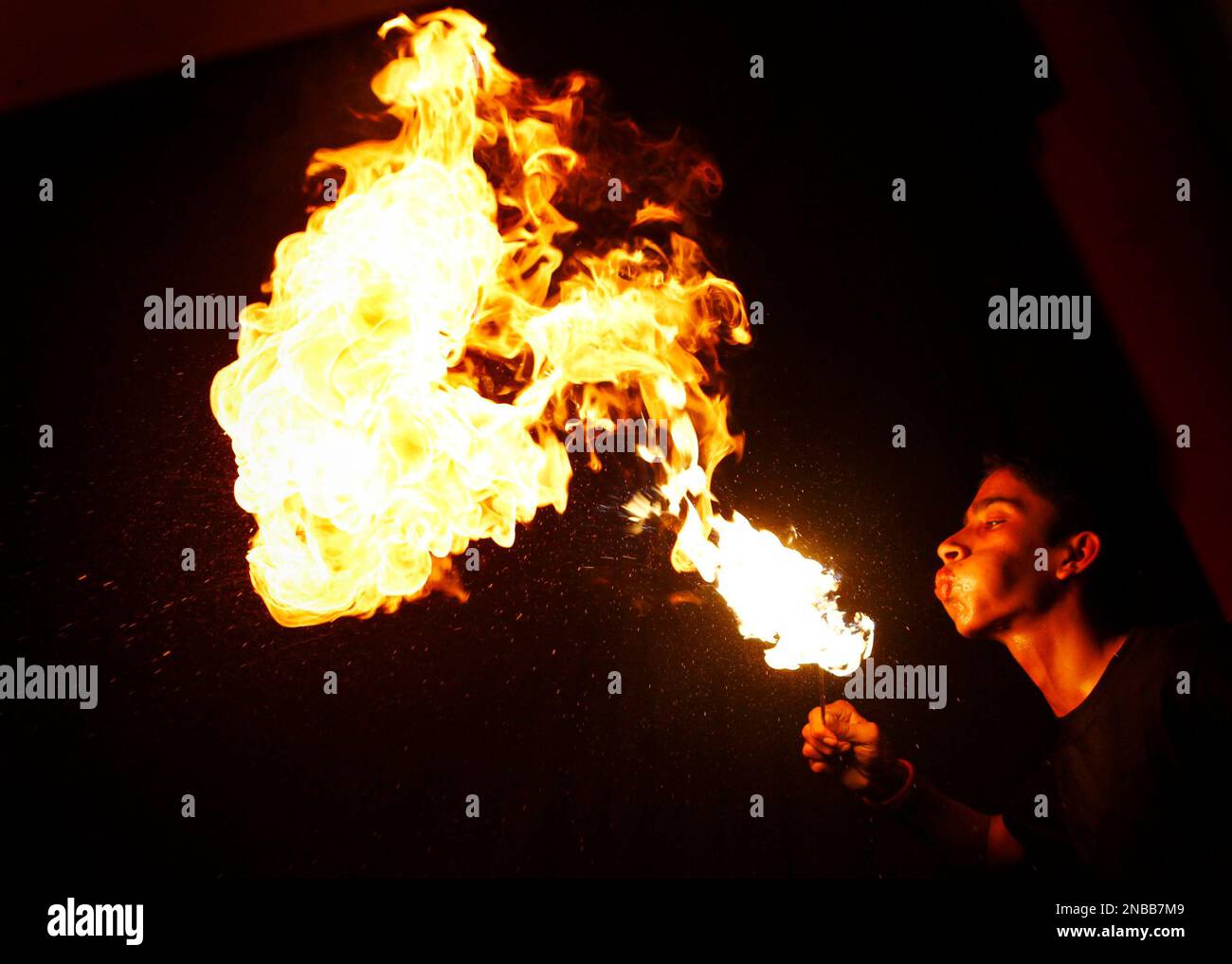 Nepal's Ambika Niraula blows a fireball in an attempt to break the ...