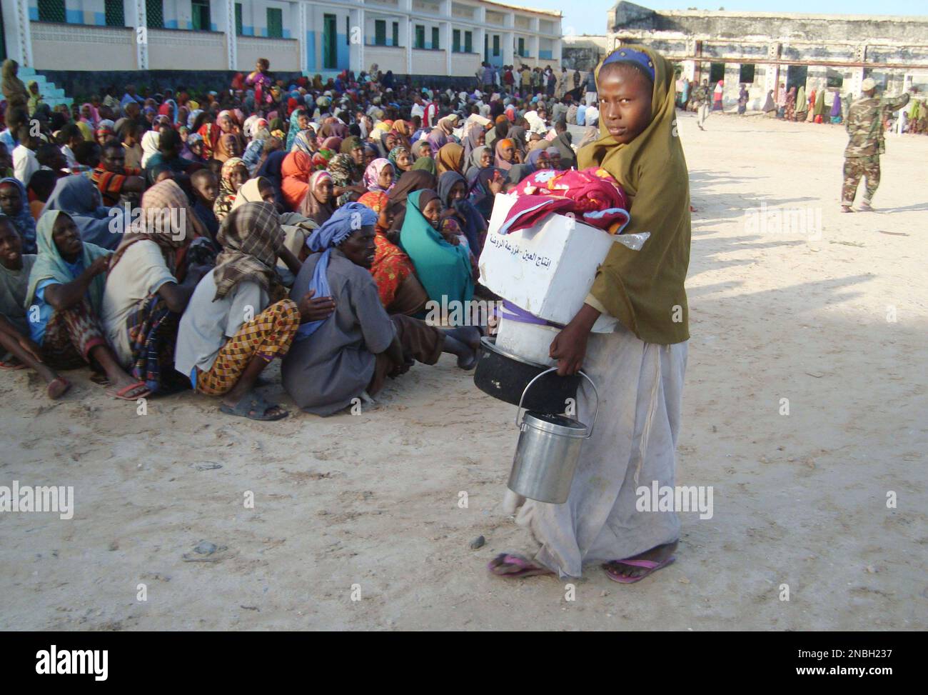 A woman walks after receiving food, money and blankets distributed by the Somali government in