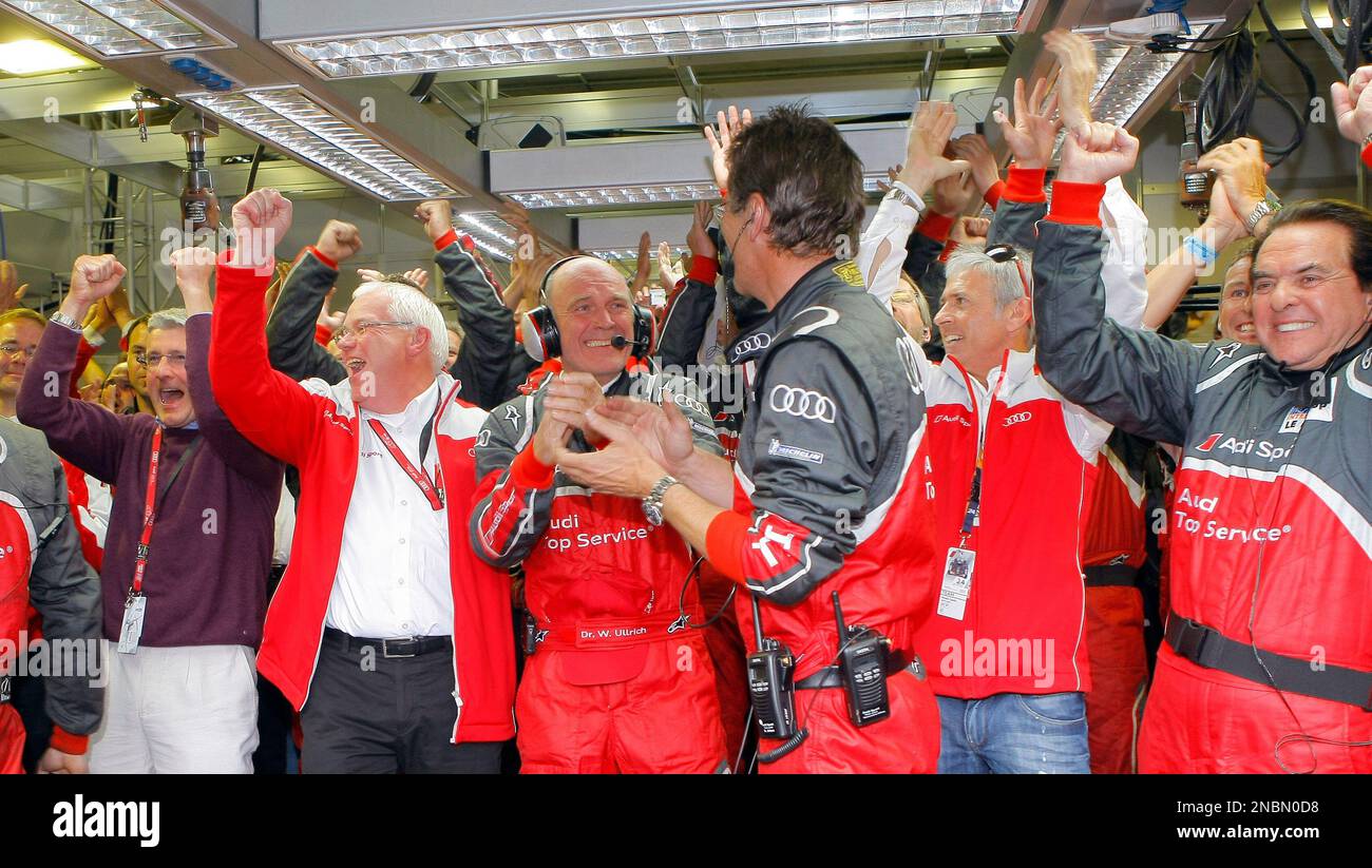 Audi motor sports chief Wolfang Ullrich, centre, reacts, after his team win the 79th 24 hours Le Mans endurance race, in Le Mans, western France, Sunday, June 12, 2011. (AP Photo/Jacques Brinon) Banque D'Images