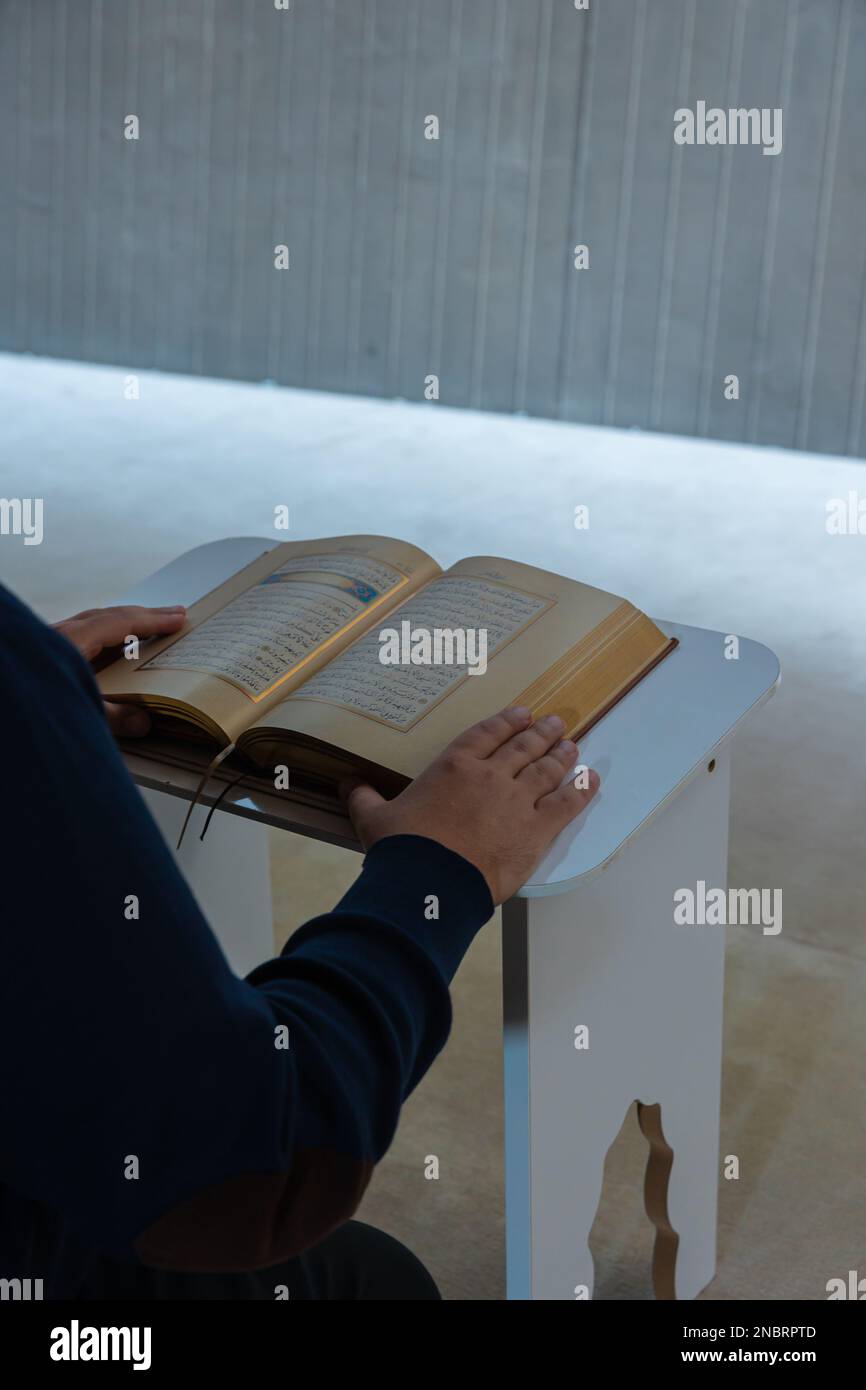 Photo de fond verticale islamique. Homme musulman lisant le Saint Coran. Ramadan ou kandil ou laylat al-qadr concept. Istanbul Turkiye - 11.12.2022 Banque D'Images