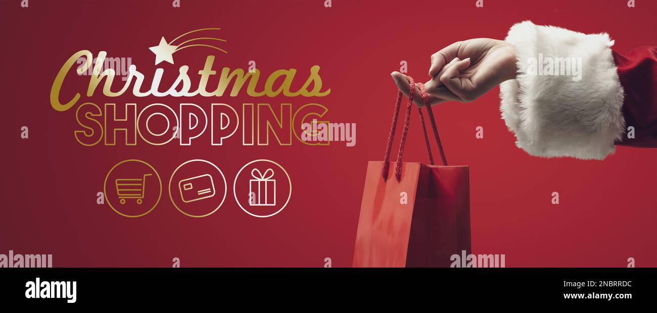 Shopping et vente de Noël : le Père Noël tient un sac rouge Banque D'Images