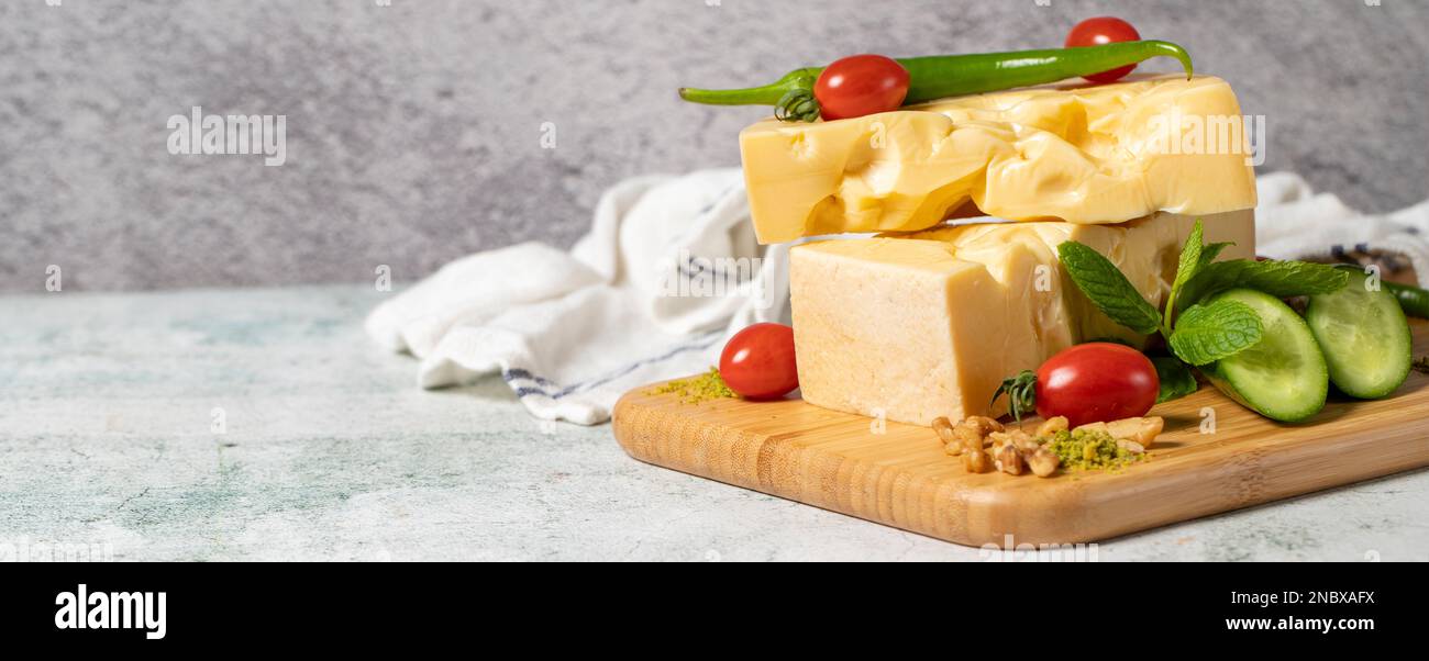 Fromage Gruyère. Morceau de fromage Gruyere sur planche à découper en bois. Collection de fromages. Espace vide pour le texte. Copier l'espace Banque D'Images