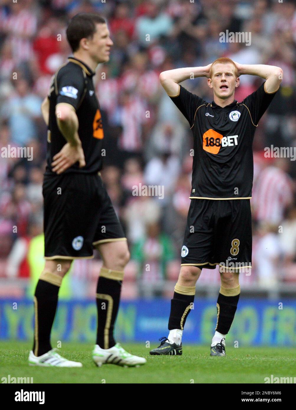 Wigan Athletic's captain Gary Caldwell, left, and Ben Watson, right, react after being defeated by Sunderland at the end of their English Premier League soccer match at the Stadium of Light, Sunderland, England, Saturday, April. 23, 2011. (AP Photo/Scott Heppell) NO INTERNET/MOBILE USAGE WITHOUT FOOTBALL ASSOCIATION PREMIER LEAGUE(FAPL)LICENCE. CALL +44 (0) 20 7864 9121 or EMAIL info@football-dataco.com FOR DETAILS Banque D'Images
