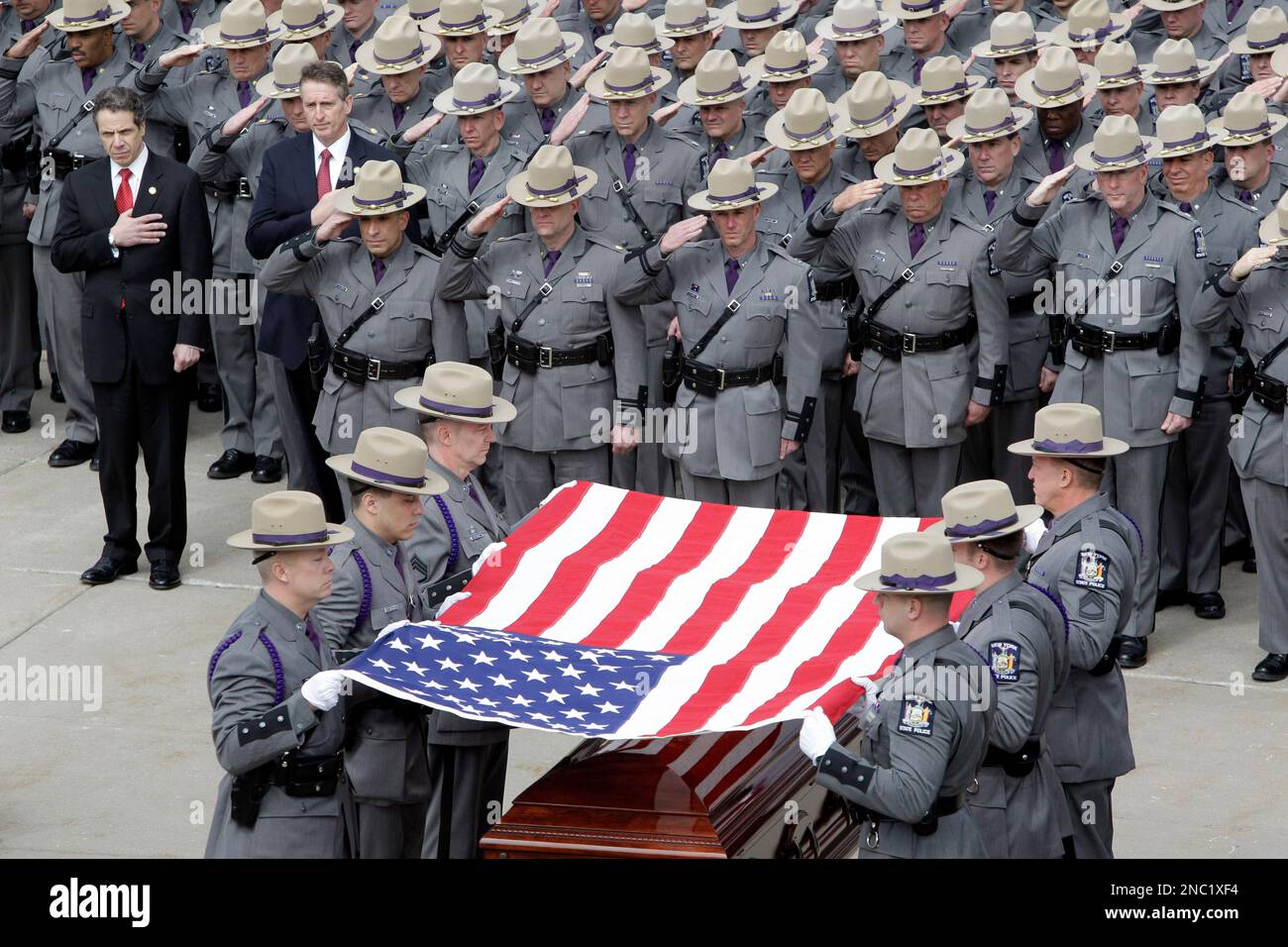 New York State Troopers fold the flag during the funeral of New York