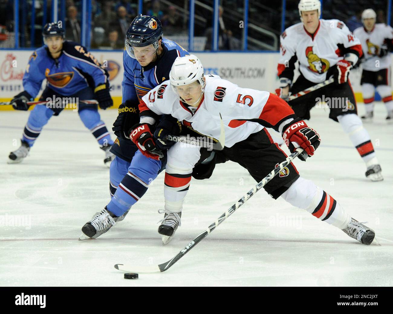 Ottawa Senators defenseman Brian Lee (5) protects the puck from Atlanta Thrashers center Ben Maxwell during the first period of an NHL hockey game, Sunday, March 27, 2011, in Atlanta. (AP Photo/John Amis) Banque D'Images