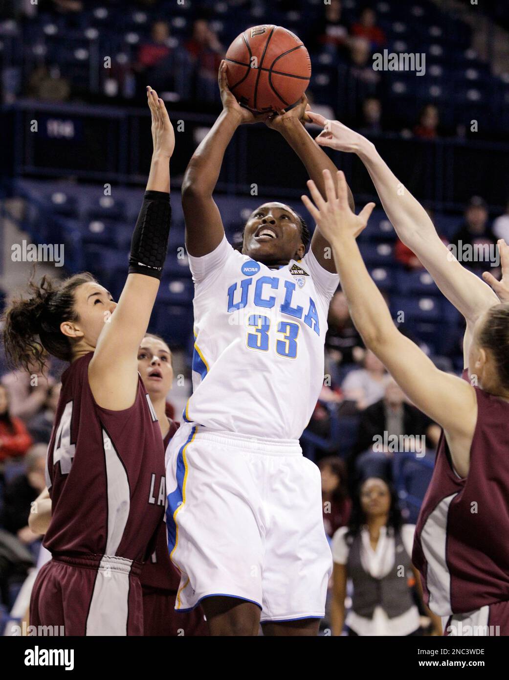 UCLA's Jasmine Dixon (33) shoots between Montana defenders in the