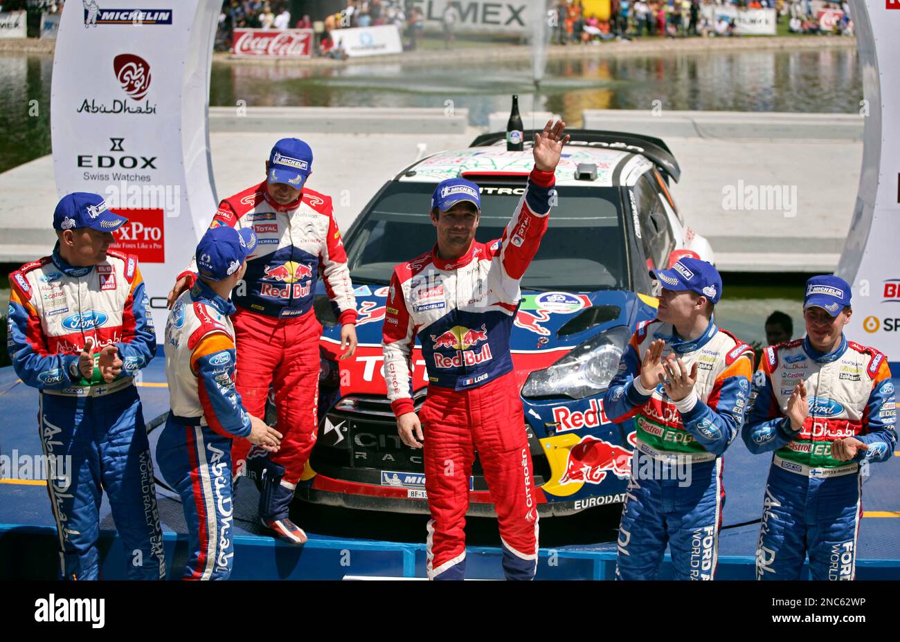 Citroen Total World Rally team driver Sebastien Loeb, third from right, from France, and co-driver Daniel Elena, third from left, from Monaco, celebrate after winning the Mexico Rally, with second place Ford Abu Dhabi World Rally Team, Mikko Hirvonen, left, and Jarmo Lehtinen, from Finland, second from left, and third place Ford Abu Dhabi World Rally Team Jari-Matti Latvala, right, and Miikka Anttila, also from Finland, in Leon, Mexico, Sunday, March 6, 2011. Loeb, a seven-time world champion, beat Finnish driver Mikko Hirvonen to win the Mexican Rally for the fifth time. Loeb took first place Banque D'Images
