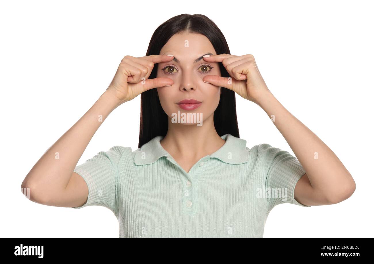 Femme vérifiant son état de santé sur fond blanc. Yeux jaunes comme symptôme de problèmes avec le foie Banque D'Images