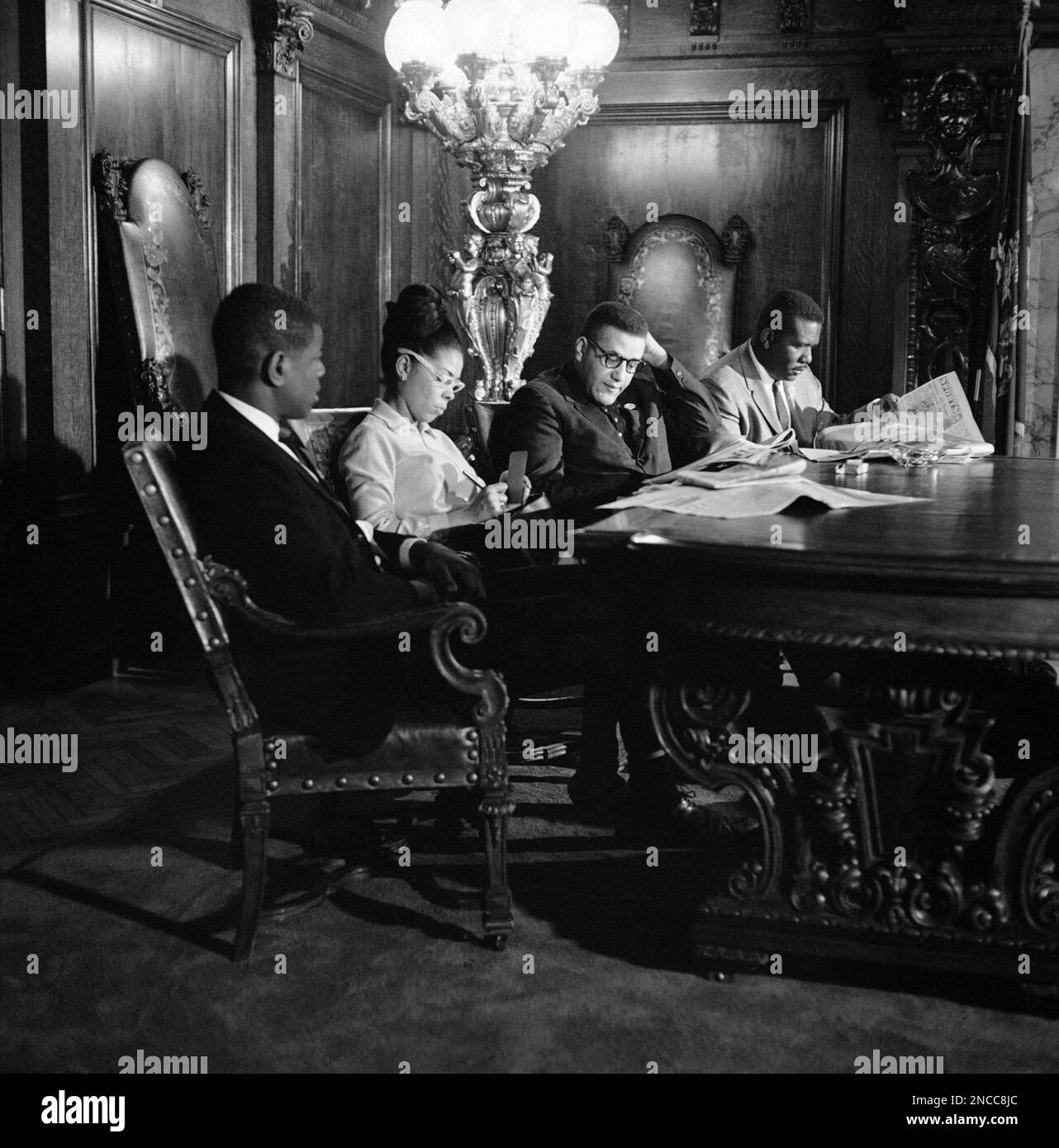 Stanley Branche, third from left, of Chester, Pa., stages a sitin in