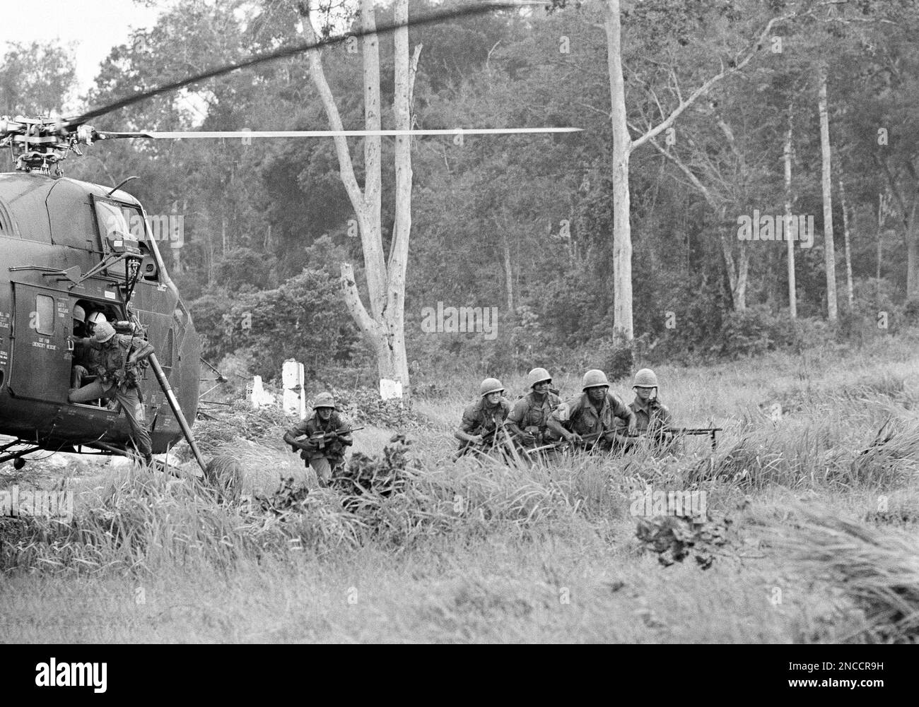 U.S., paratroopers form up as they leap from helicopter for strike