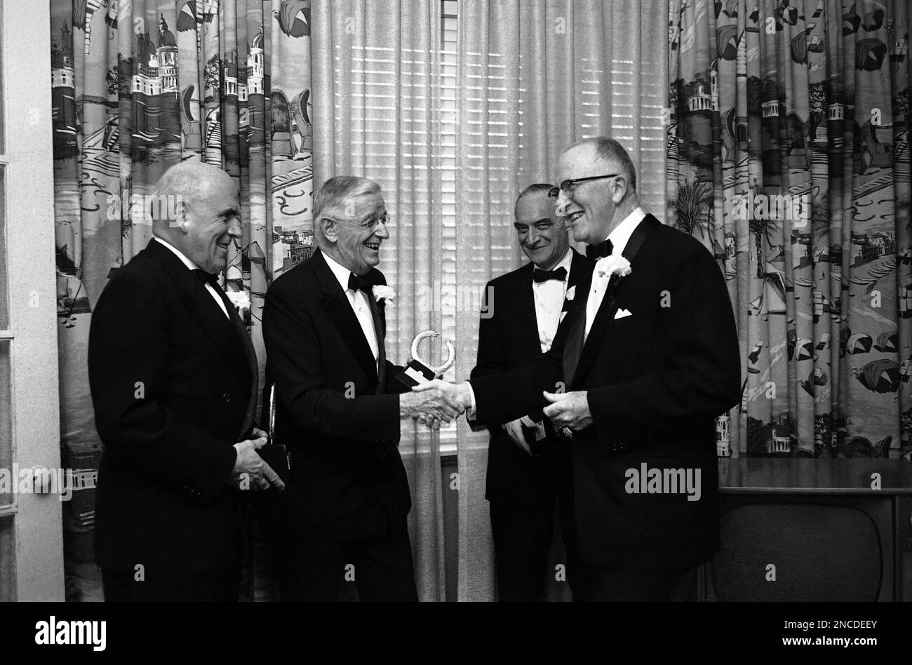 The U.S. Chamber of Commerce presented “Great Living American” awards to three men for “unique and creative contributions to human progress” on April 27, 1964. The men, from left, are: John McCloy, New York banker-lawyer; Dr. Vannevar Bush, chairman of the Corporation of the Massachusetts Institute of Technology, and Gen. Lucius Clay, former military governor of postwar Germany. At right is Ladd Plumley, chairman of the board of the Chamber, who presented the awards. (AP Photo/John Rous) Banque D'Images