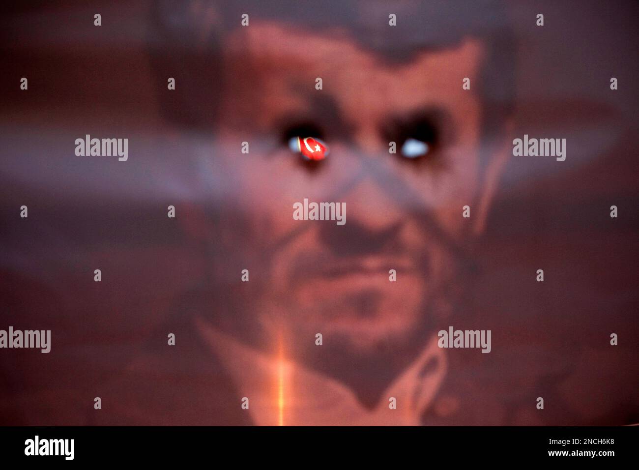 ** FOR USE AS DESIRED, YEAR END PHOTOS ** FILE -In this May 31, 2010 file photo, a Turkish flag is seen trough a depiction of Iranian President Mahmoud Ahmadinejad whose eyes have been punctured, during a demonstration in support of Israel following a deadly raid by Israel's navy on an aid flotilla bound for the blockaded Gaza Strip, outside the Turkish embassy in Tel Aviv, Israel. (AP Photo/Oded Balilty, File) Banque D'Images