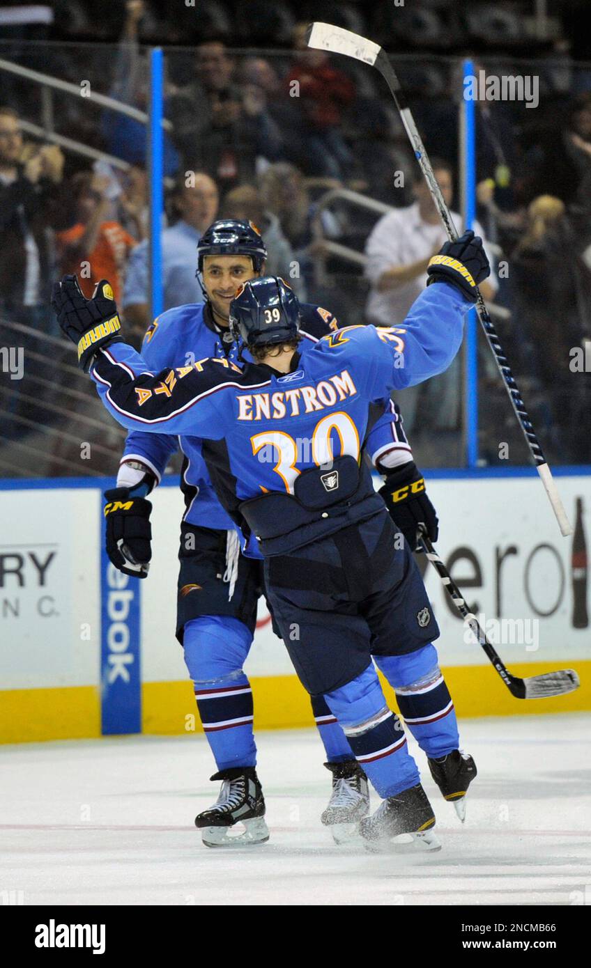 Atlanta Thrashers defensemen Dustin Byfuglien, rear, celebrates his gameending goal against the