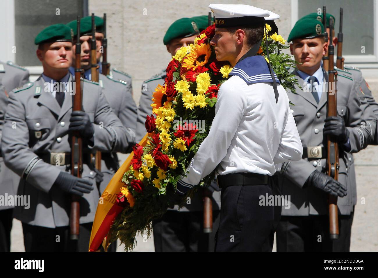 German soldiers carry a wreath during a ceremony at the courtyard of ...