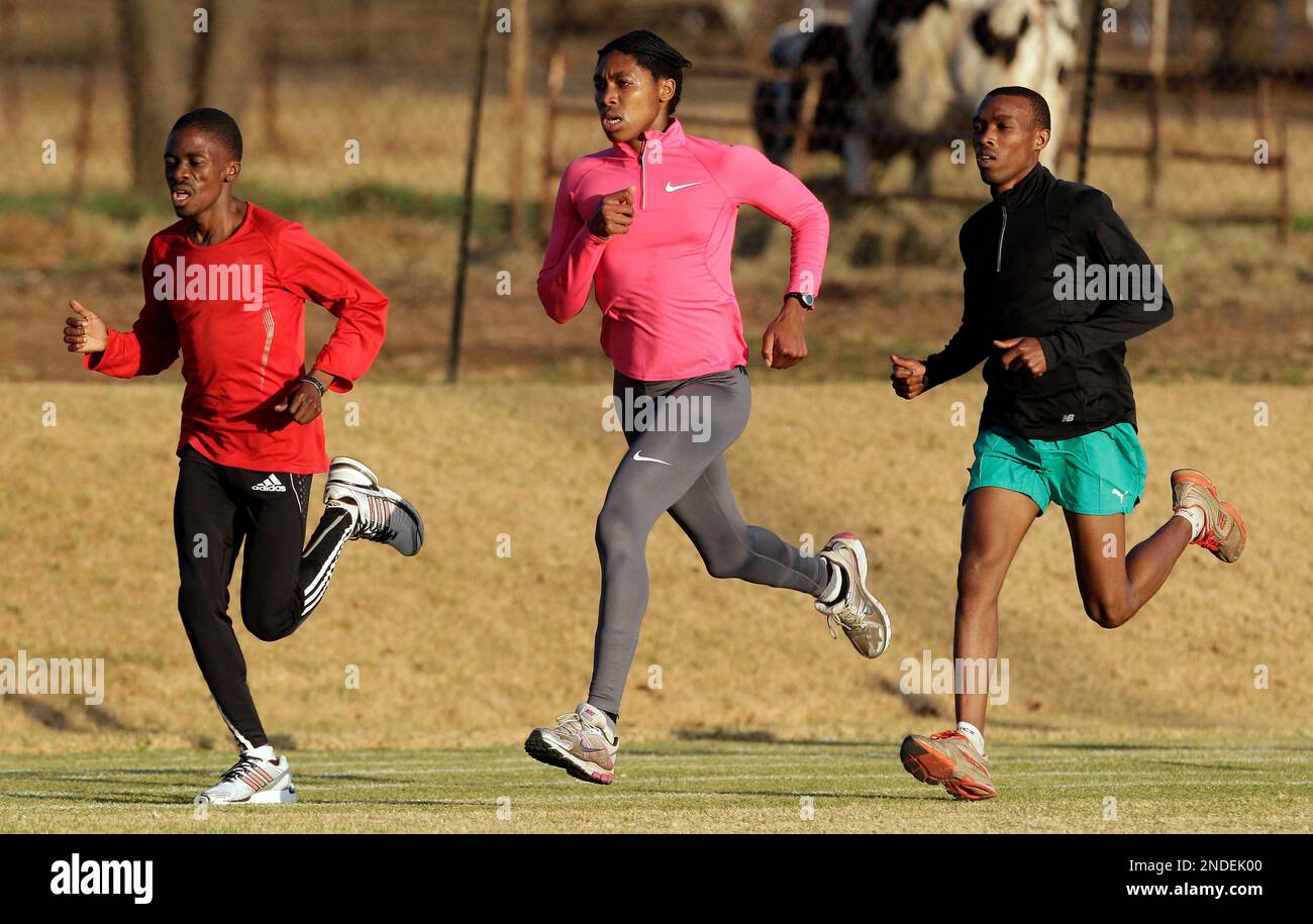 South African track and field athlete Caster Semenya, center, jogs during a training session in
