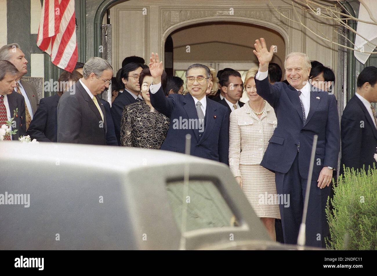 Keizo Obuchi, Prime Minister of Japan, second from left, waves with his ...
