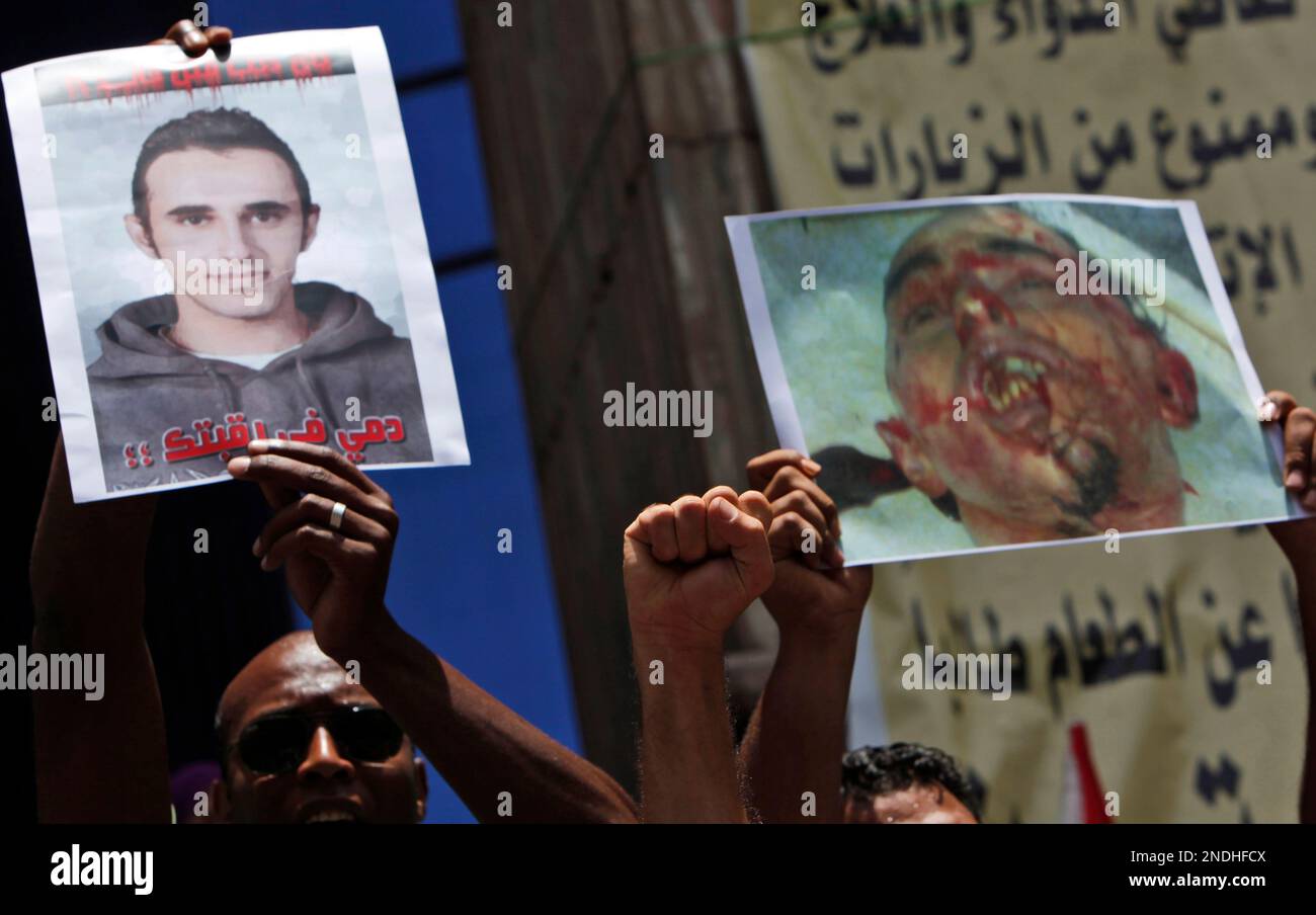 Activists chant anti government slogans and carry pictures of slain Khaled Said during a protest following a press conference for the family at the Egyptian Journalists Syndicate in Cairo, Egypt, Saturday, June 19, 2010. Khaled Said was allegedly beaten to death by two plainclothes policemen on an Alexandria street after he posted a video on the Internet of police officers sharing the spoils from a drug bust among themselves, his family said. (AP Photo/Nasser Nasser) Banque D'Images