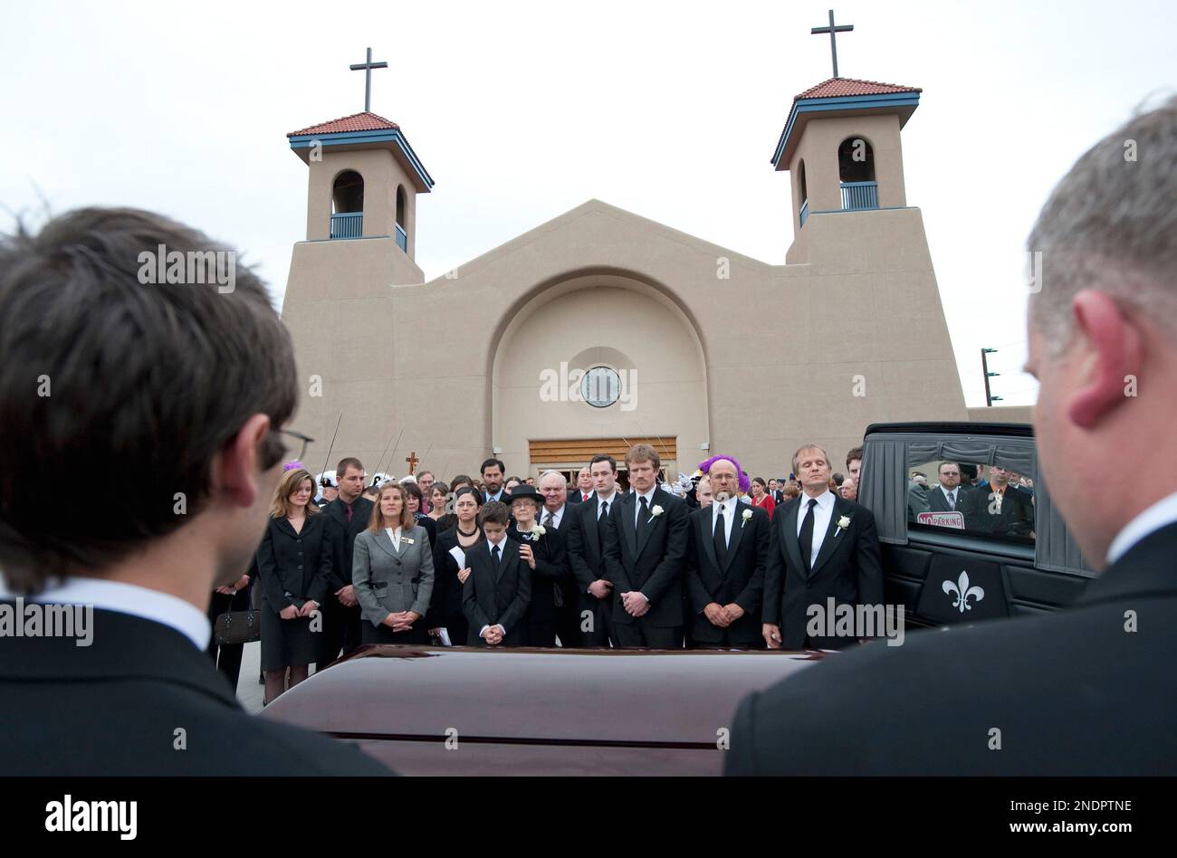 Members of the Hickel family gather around the casket of former Alaska