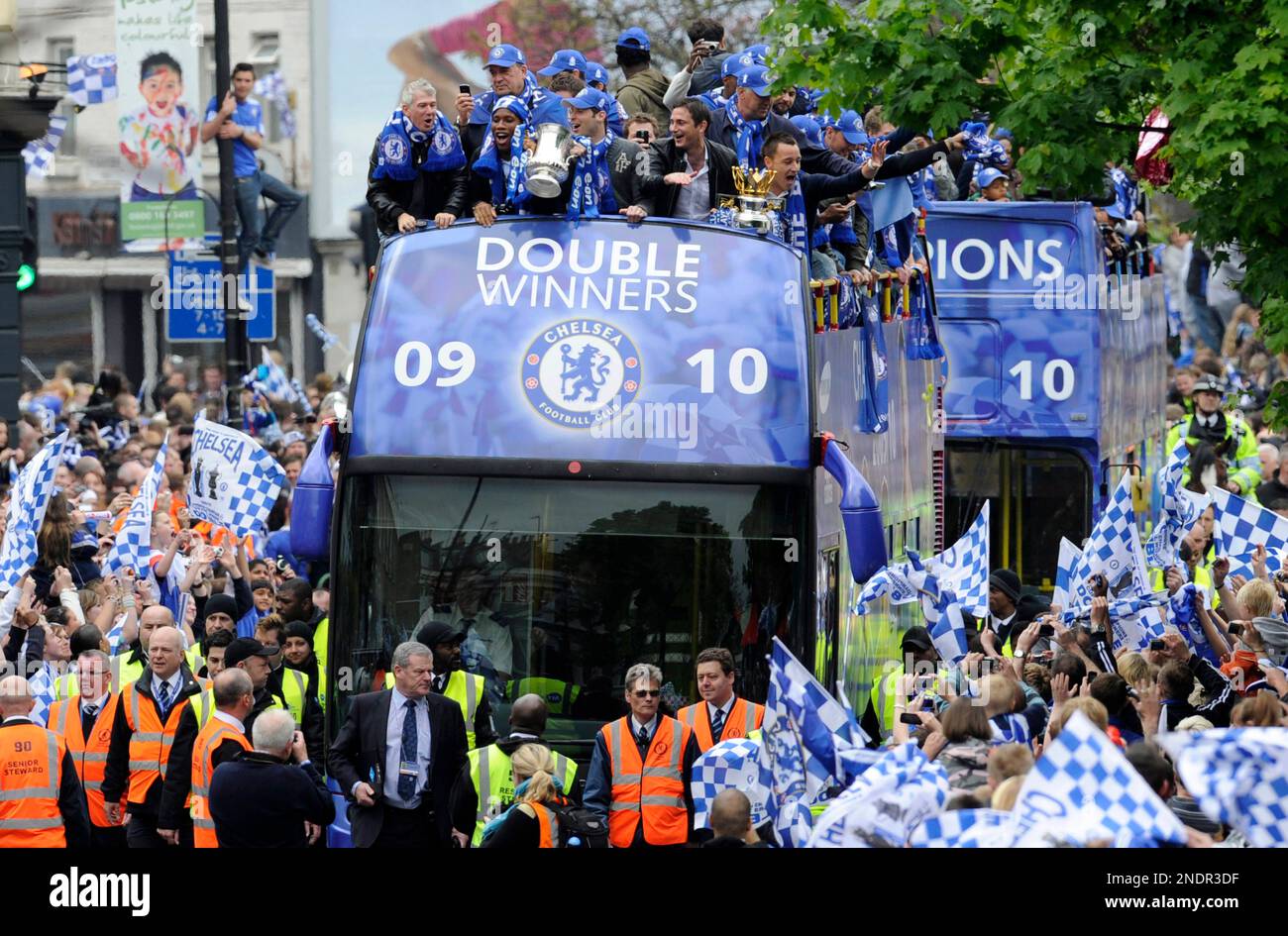 The Chelsea team react from the top of a bus displaying their trophies, as fans line the streets, during a victory parade, in London, Sunday May 16, 2010. Chelsea overcame a resilient Portsmouth side, to win a dramatic FA Cup final 1-0 and clinch their first League and Cup Double on Saturday. (AP Photo/Tom Hevezi) Banque D'Images