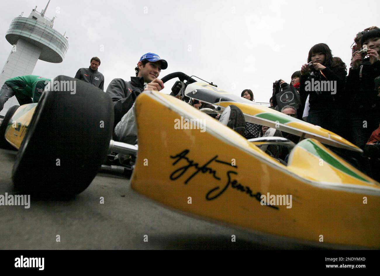 Hispania Racing Team Formula One driver Bruno Senna of Brazil sits in a go-cart with the name of his late uncle, Aryton Senna, written on the side of it at a promtional event prior to the start of Chinese Formula One Grand Prix at the Shanghai International Circuit in Shanghai, China, Thursday, April 15, 2010. (AP Photo/Eugene Hoshiko) Banque D'Images