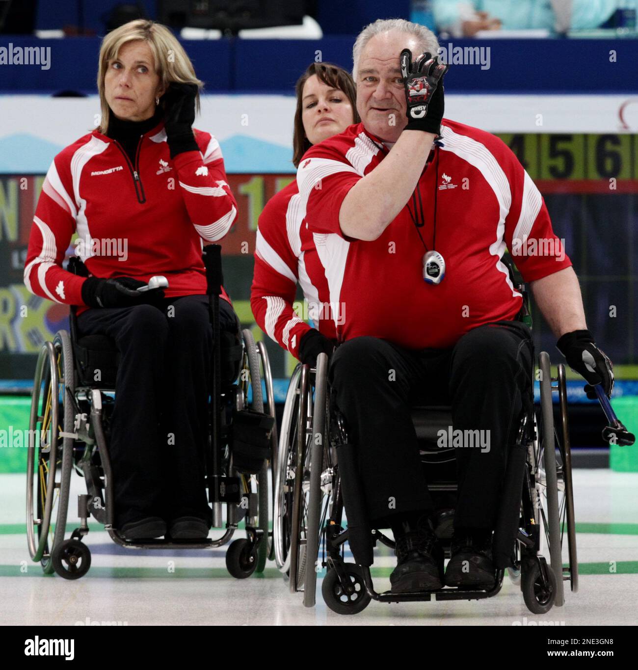 Canada's Sonja Gaudet, left to right, Ina Forrest and skip Jim Armstrong look on while playing South Korea during the gold medal wheelchair curling match at the 2010 Winter Paralympics in Vancouver, B.C., on Sunday March 20, 2010. THE CANADIAN PRESS/Darryl Dyck Banque D'Images