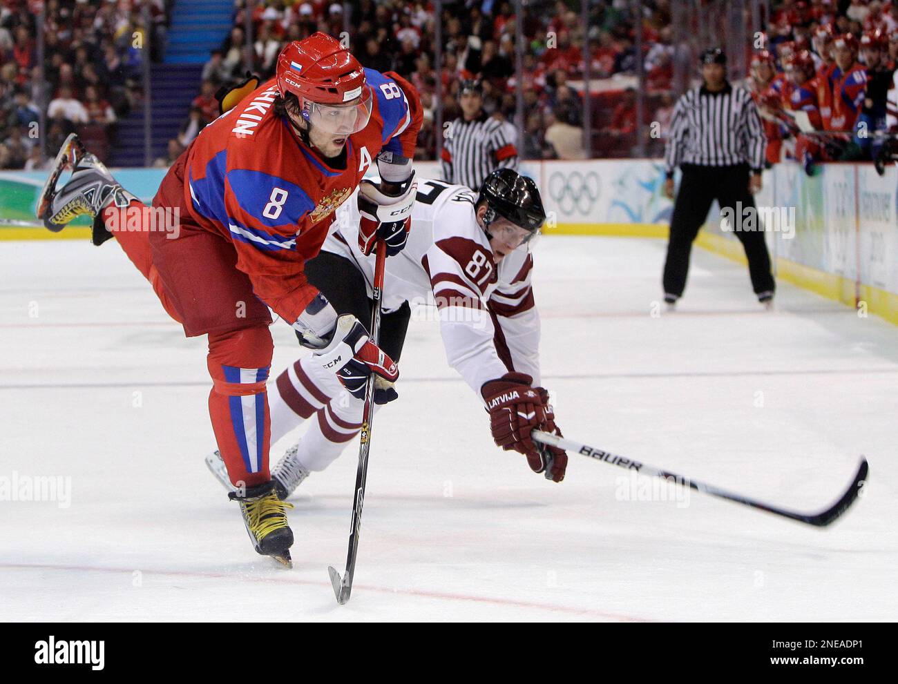 Russia's Alexander Ovechkin (8) passes the puck away from Latvia's Gints Meija (87) in the first period of a preliminary round men's ice hockey game at the Vancouver 2010 Olympics in Vancouver, British Columbia, Tuesday, Feb. 16, 2010. (AP Photo/Matt Slocum) Banque D'Images
