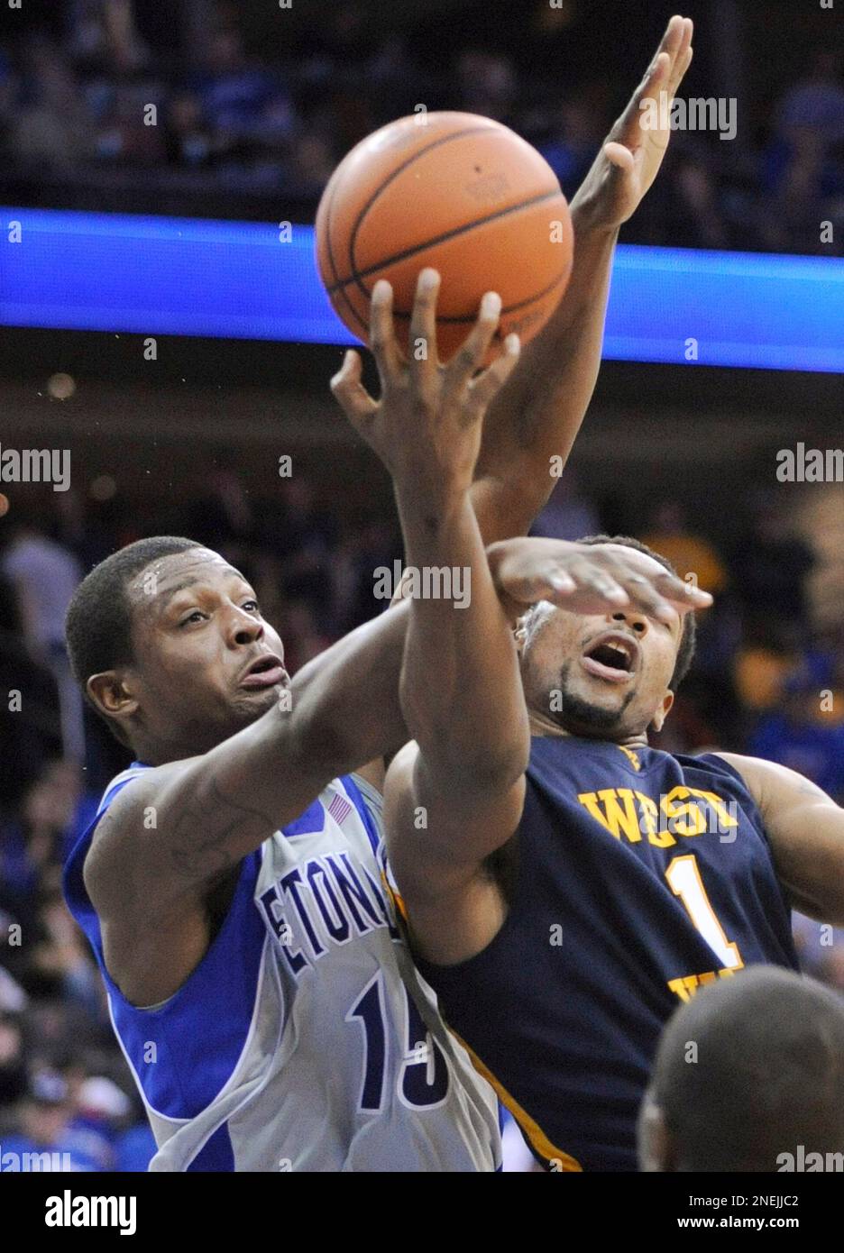 Seton Hall's Herb Pope, left, fouls West Virginia's Da'Sean Butler as