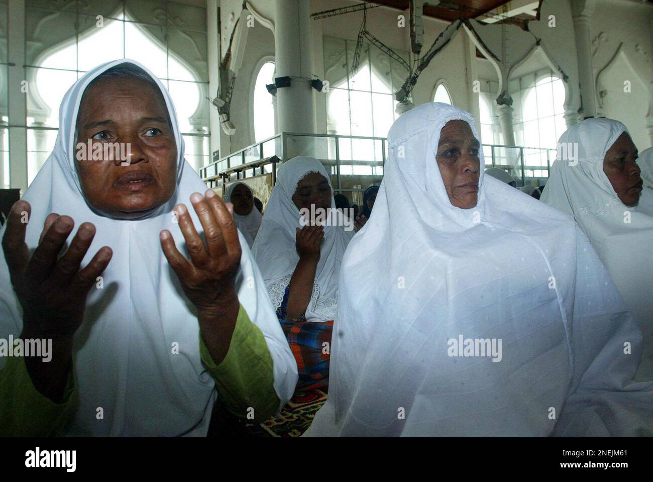 Acehnese women take part in a prayer for the victims of Indian Ocean tsunami in Lhoong, Aceh province, Indonesia, Friday, Dec. 25, 2009. A giant quake in Indian Ocean on Dec. 26, 2004, triggered a massive tsunami that killed 230,000 people, half of them in Aceh. (AP Photo/Heri Juanda) Banque D'Images