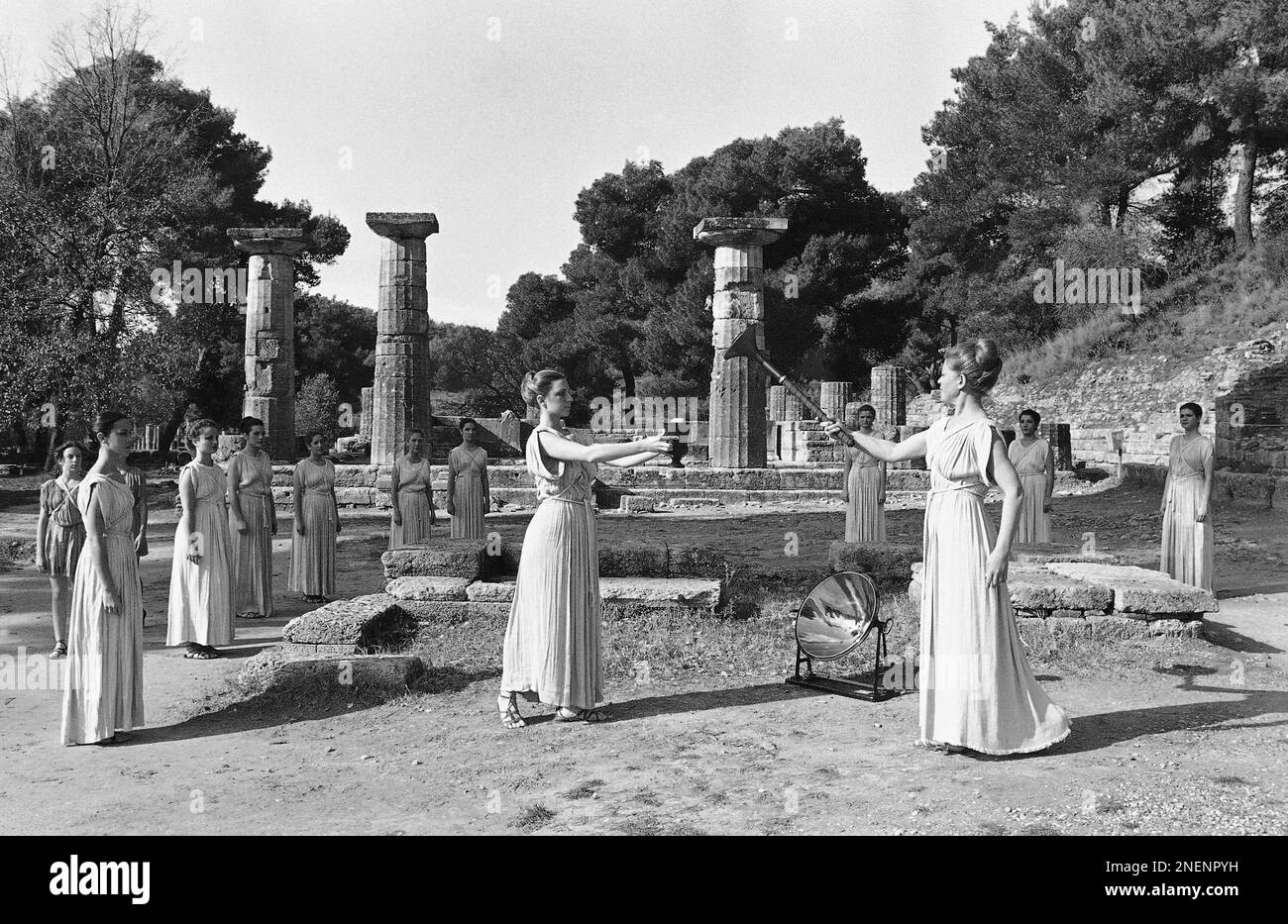 Greek actress Maria Moscholiou, handing over the Olympic Flame to the first runner here, Jan. 29, 1980 in Ancient Olympia, Greece, during general rehearsal. The flame will leave Athens on Wednesday for the Winter Olympic Games in Lake Placid, USA. (AP Photo/Saris) Banque D'Images