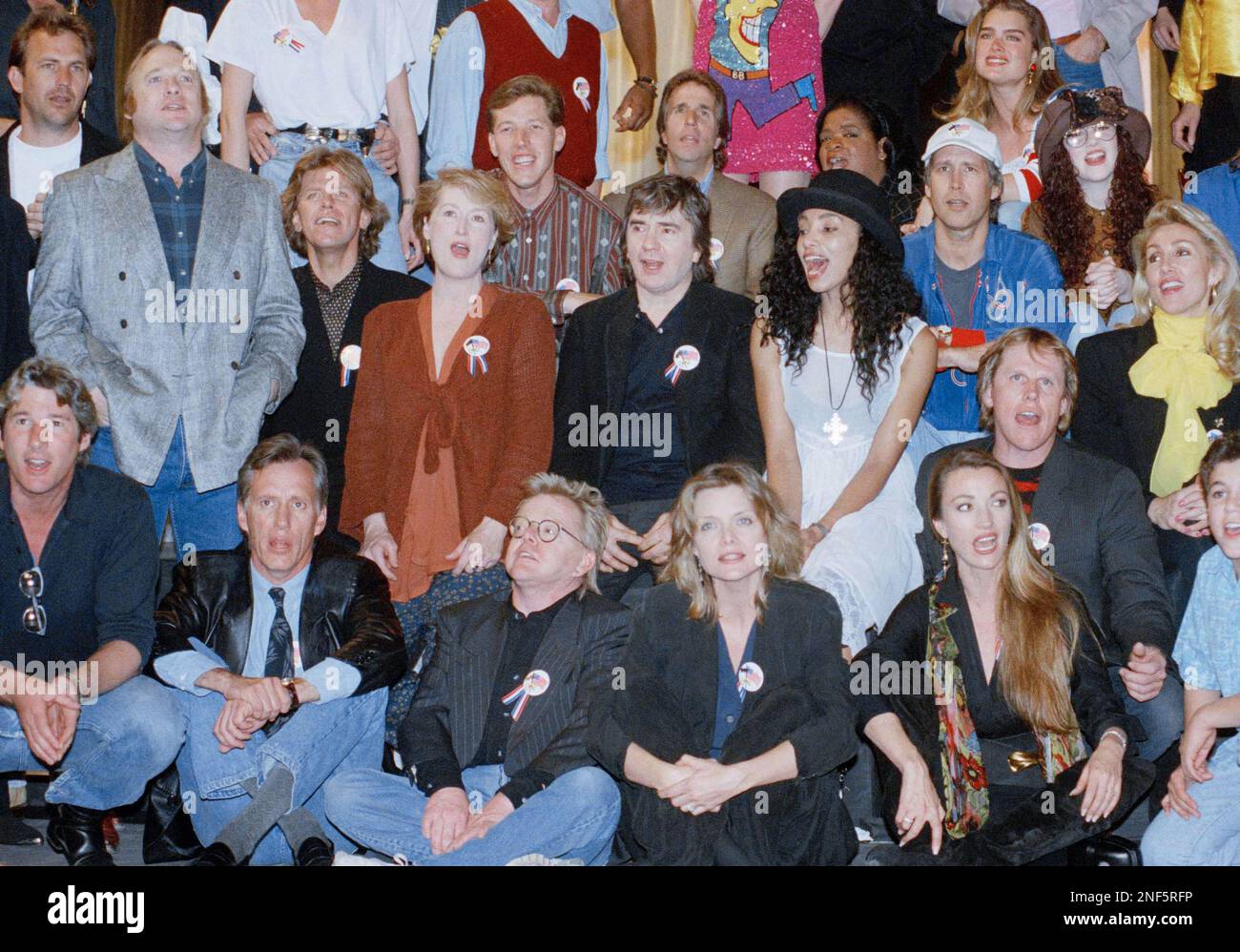 Part of a group of over 100 celebrities sing during a playback of their