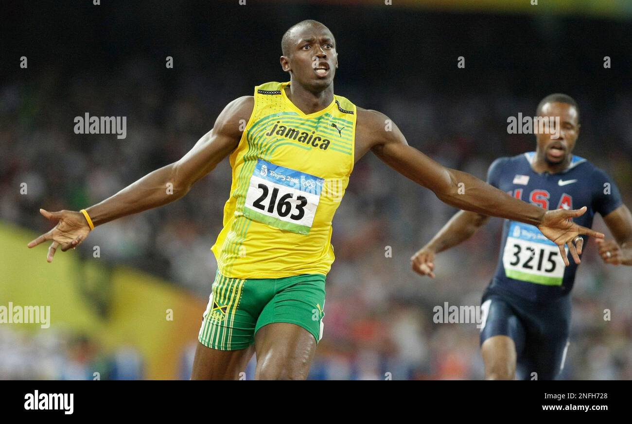Usain Bolt of Jamaica reacts after winning the men's 100-meter final with a world record in athletics competitions in the National Stadium at the Beijing 2008 Olympics in Beijing, Saturday, Aug. 16, 2008. At right is Darvis Patton of the United States. (AP Photo/Anja Niedringhaus) Banque D'Images