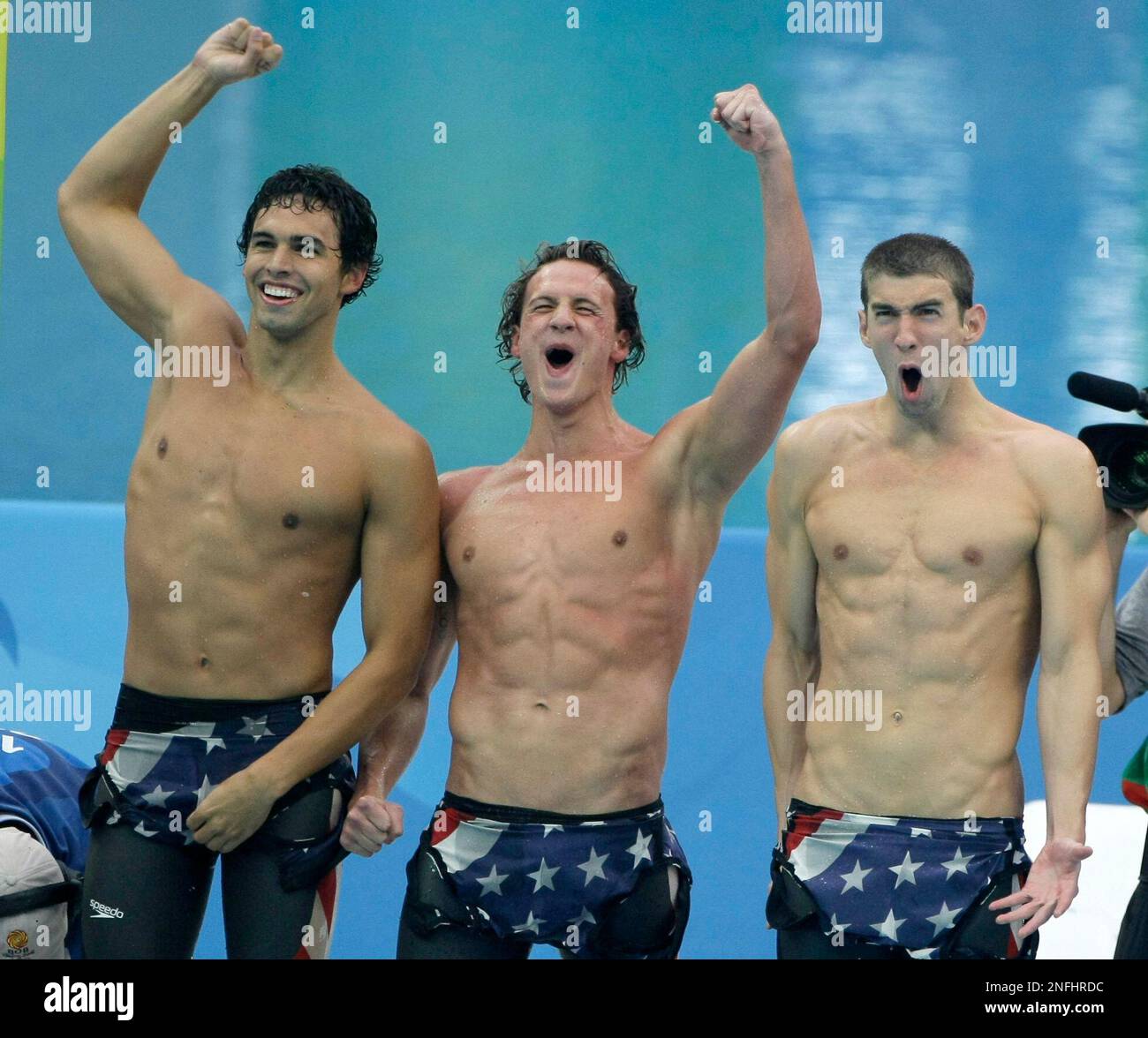 U.S. swimmers, from left, Ricky Berens, Ryan Lochte and Michael Phelps celebrate winning the gold medal as they set a new world record in the men's 4x200-meter freestyle relay final during the swimming competitions in the National Aquatics Center at the Beijing 2008 Olympics in Beijing, Wednesday, Aug. 13, 2008. (AP Photo/Anja Niedringhaus) Banque D'Images