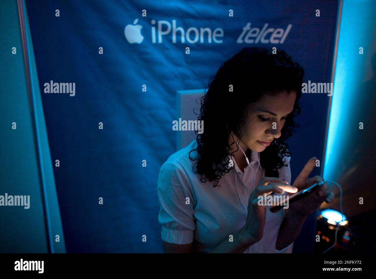 A model uses an Apple iPhone 3G during its presentation by Mexican mobile  carrier Telcel, in Mexico City, Wednesday, July 9, 2008. America Movil,  Latin America's largest mobile phone service provider, which