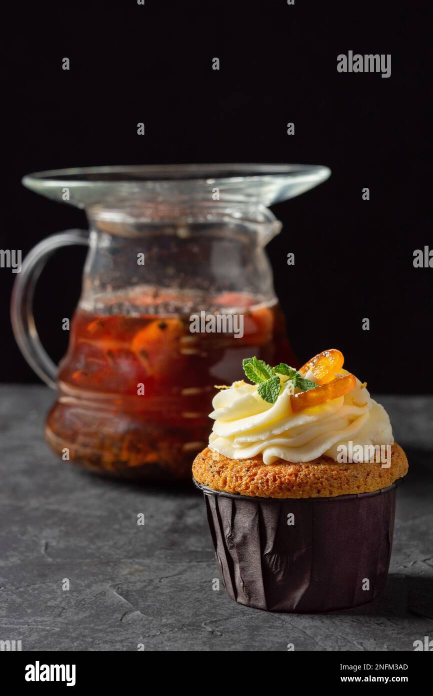 Cupcakes à la crème au fromage, décorés de baies sucrées sur fond sombre Banque D'Images