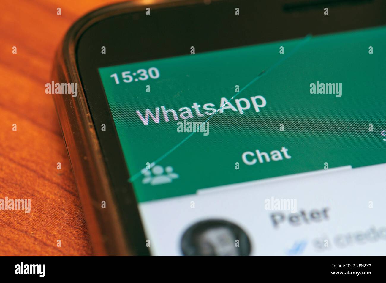 Application WhatsApp sur smartphone avec écran fissuré Banque D'Images