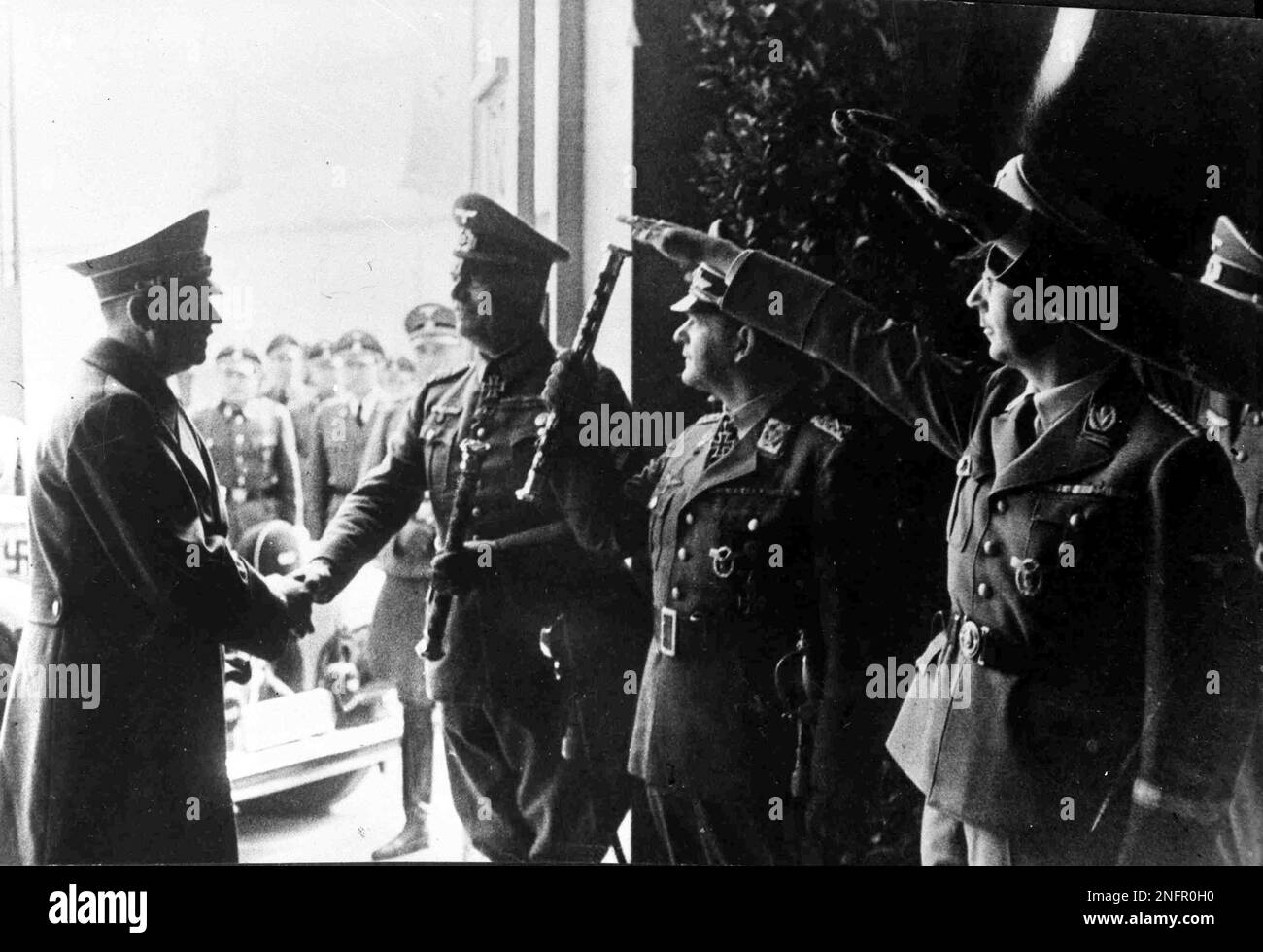 German Chancellor Adolf Hitler, left, shakes hands with Field Marshal General Wilhelm Keitel upon his arrival at the Sports Palace, Berlin, Jan. 8, 1943. Others seen saluting are Reichsfuhrer Heinrich Himmler, right, and Field Marshal Erhard Milch salutes with a Marshal's Baton, second right. (AP Photo) Banque D'Images