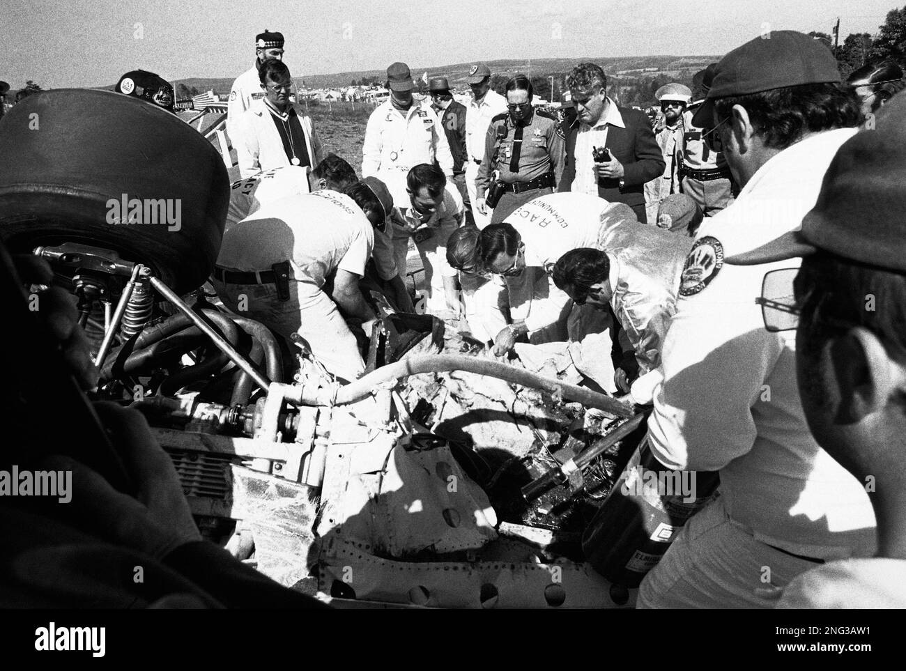 Race workers remove the body of French race driver Francois Cevert from