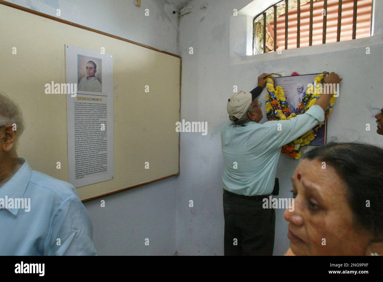 Tourists garland the portrait of Indian freedom fighter Veer Savarkar