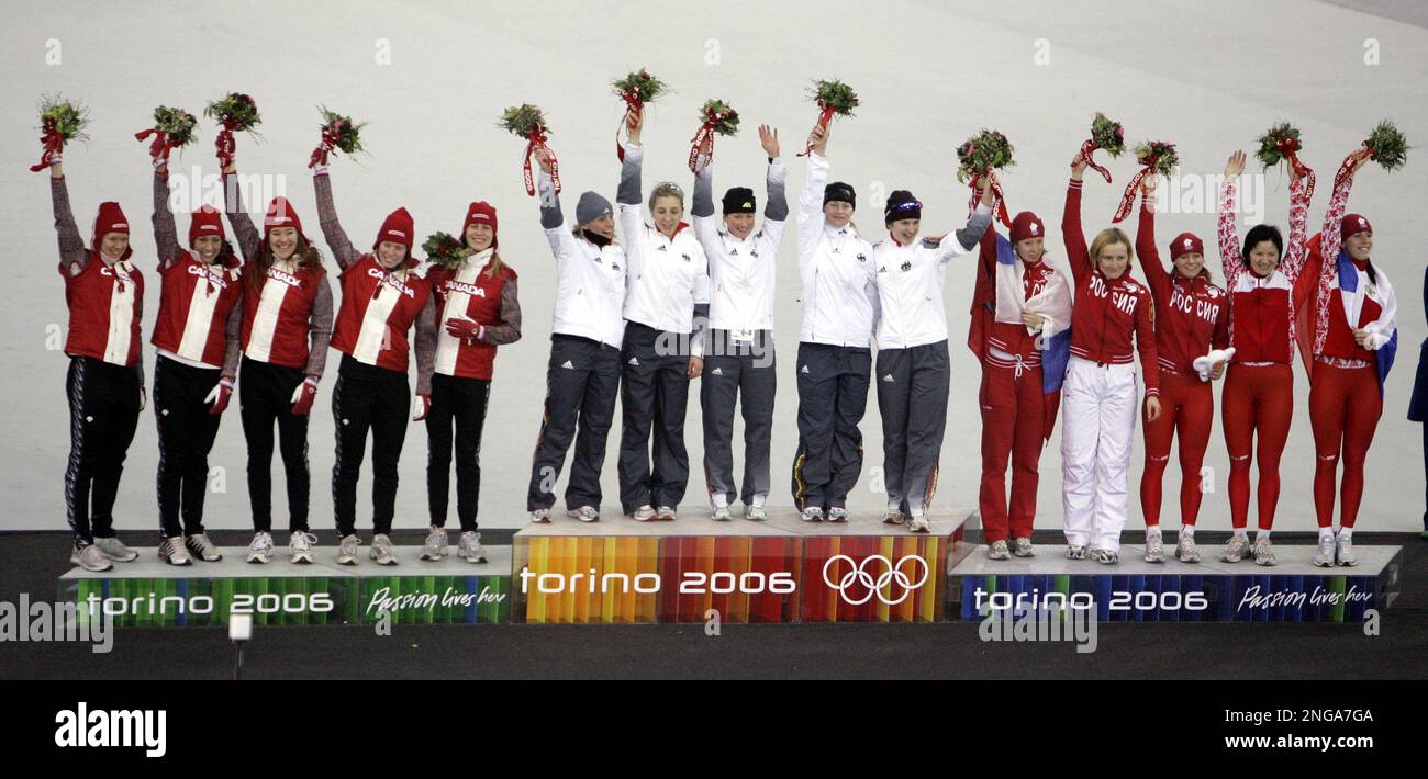 From left to right, silver medalists from Canada, gold medalists from Germany and bronze medalists from Russia celebrate during the flower ceremony after the final round of the women's team pursuit speedskating at Oval Lingotto during the 2006 Winter Olympics in Turin, Italy on Thursday, Feb. 16, 2006. (AP Photo/Jasper Juinen) Banque D'Images