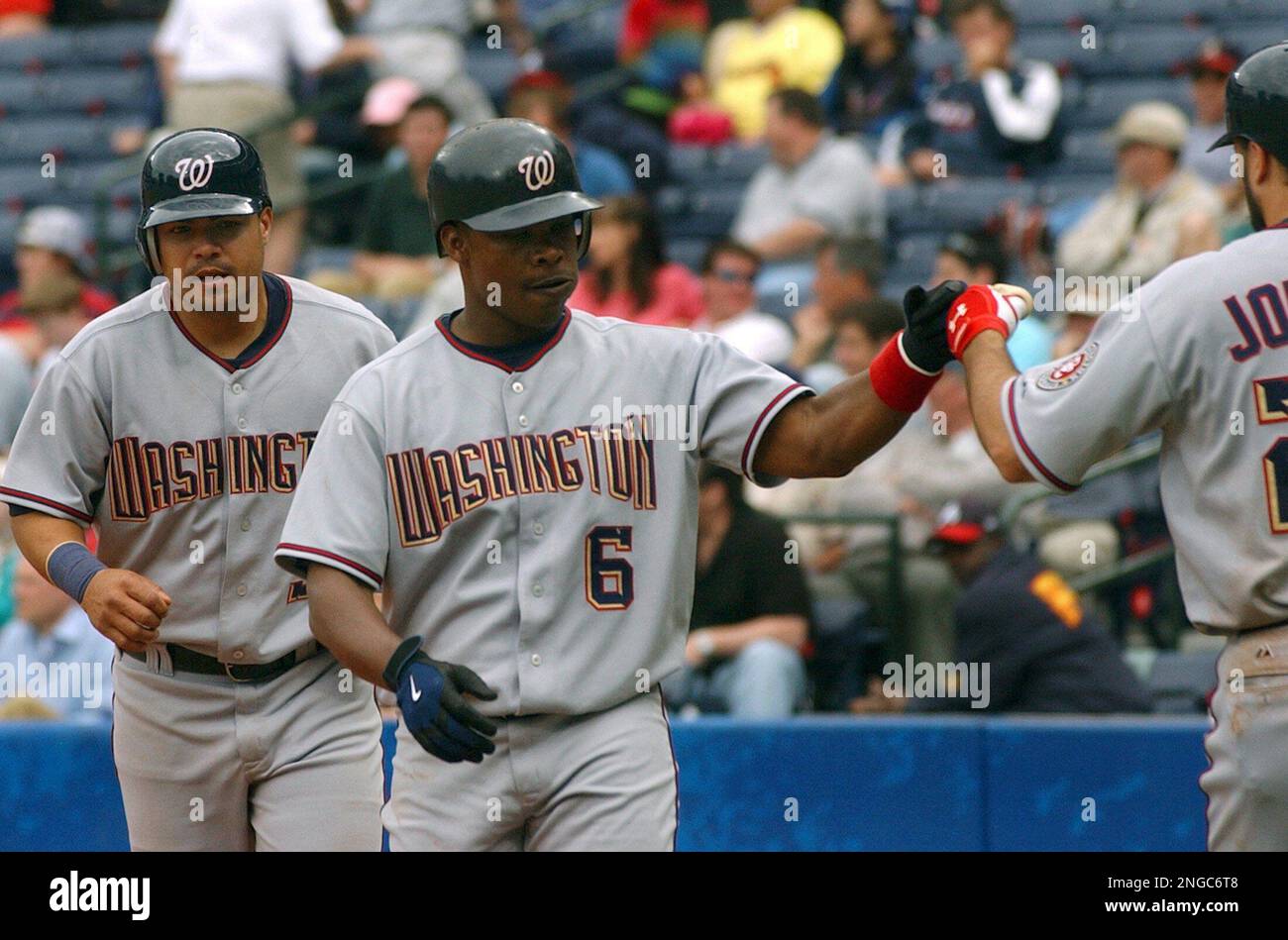 Washington Nationals' Jose Guillen (6) celebrates his two-run home run against the Atlanta Braves with teammates Nick Johnson, right, and Jose Vidro, left, during the ninth inning Wednesday, April 13, 2005, in Atlanta. The Nationals won 11-4. Guillen brought Vidro home on the play. Guillen also hit a home run in the seventh. (AP Photo/Gregory Smith) Banque D'Images