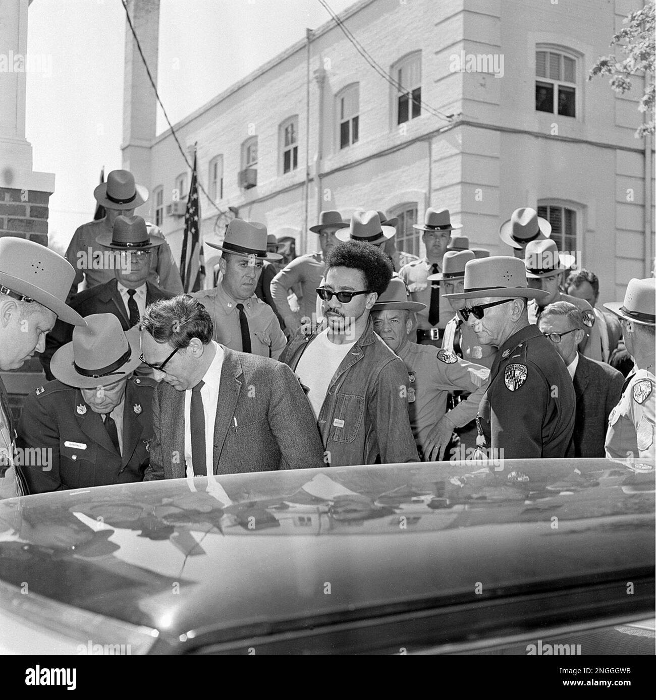 Black Power movement advocate H. Rap Brown, center wearing sunglasses, leaves the Dorchester County courthouse following his arraignment in Cambridge, Ma., April 18, 1968. Brown, who was freed on bond, was charged with inciting to riot stemming from a speech he made in Cambridge last summer which was followed by violence and fires. Brown's attorney William Kuntzler is at left. (AP Photo) Banque D'Images